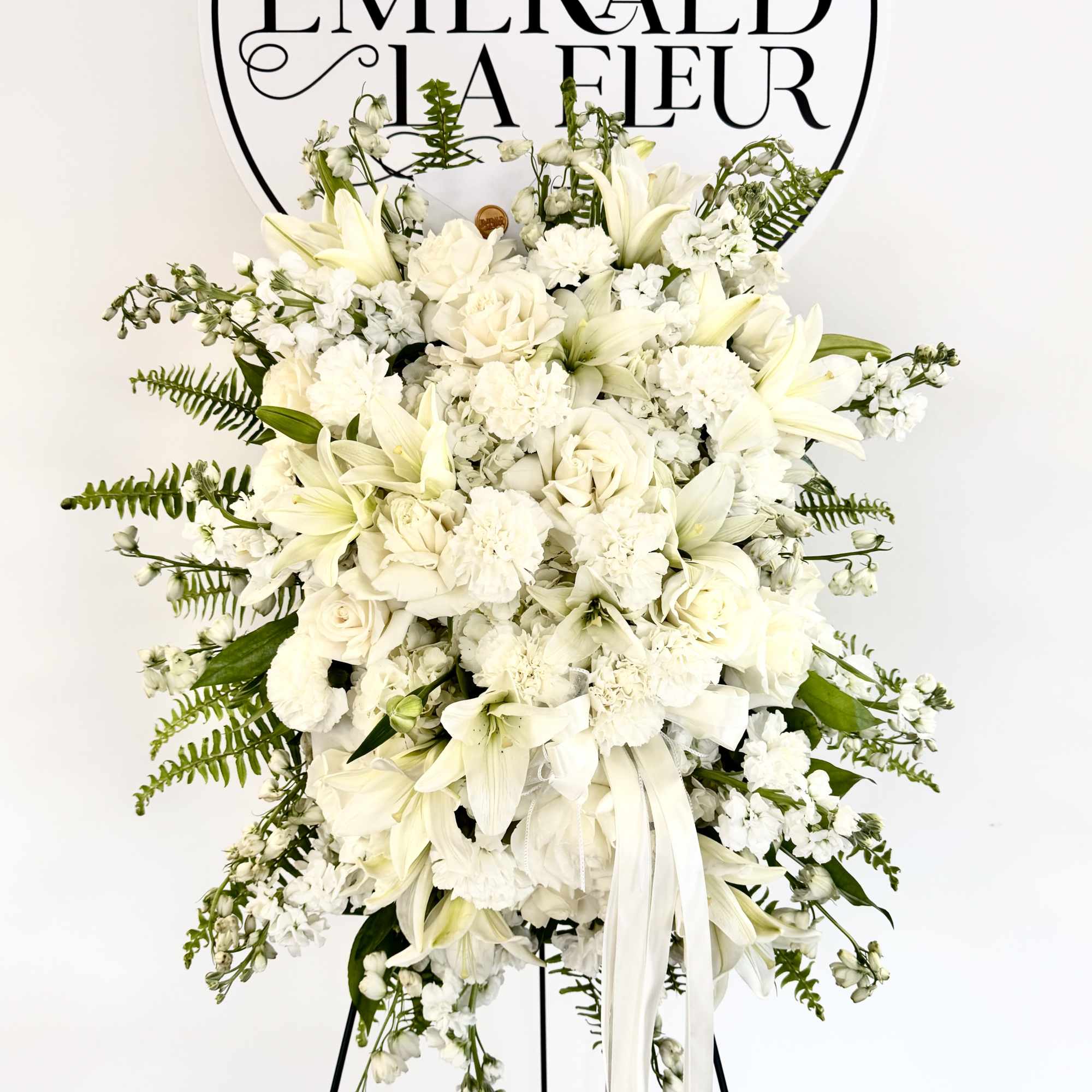 An all white tribute, this funeral spray is pure and tranquil. Featuring