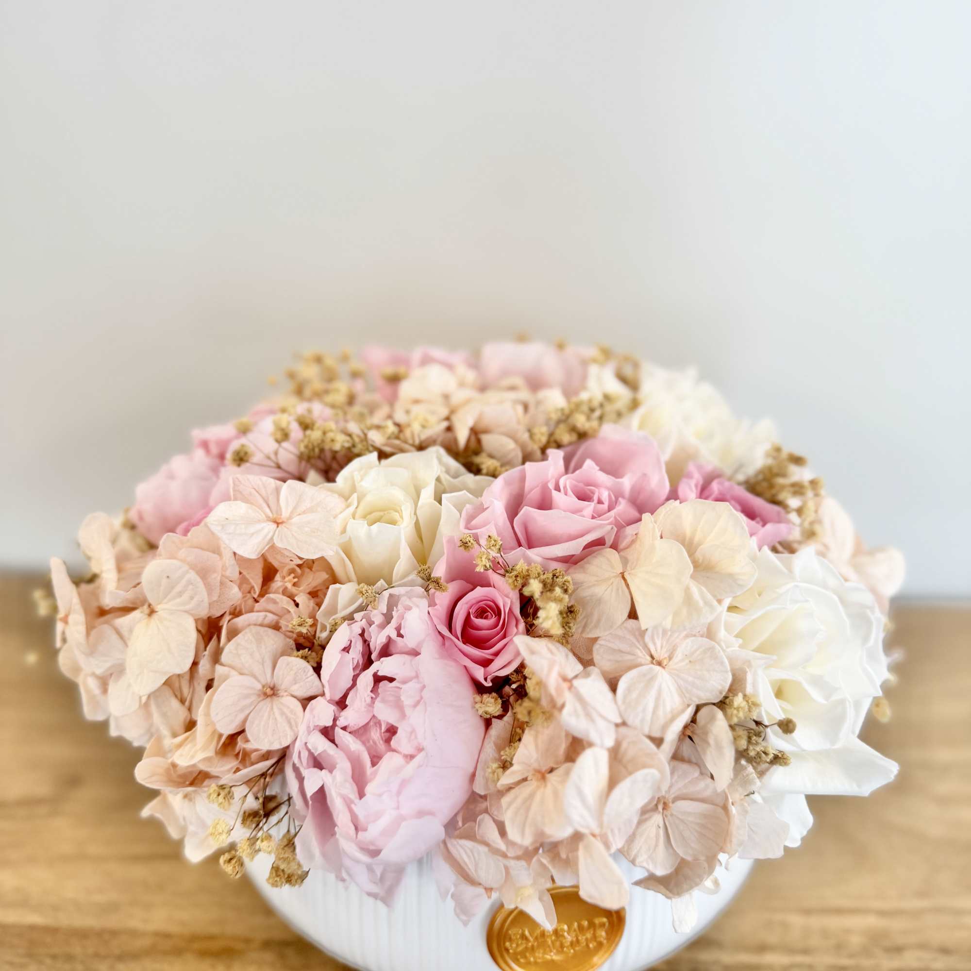 A timeless garden-inspired arrangement featuring premium preserved roses, hydrangeas, peonies, and delicate