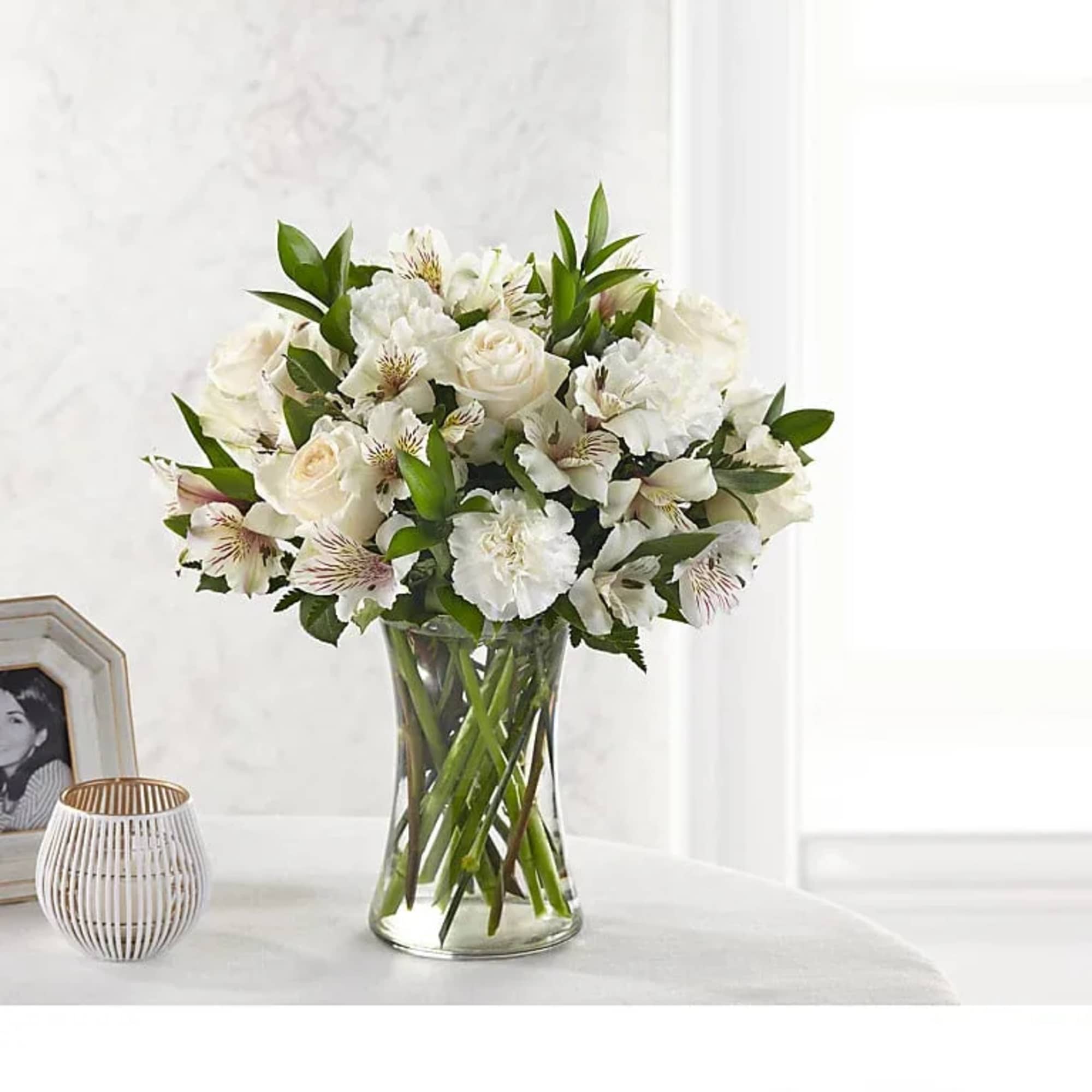 White roses and alstroemeria in a clear glass vase