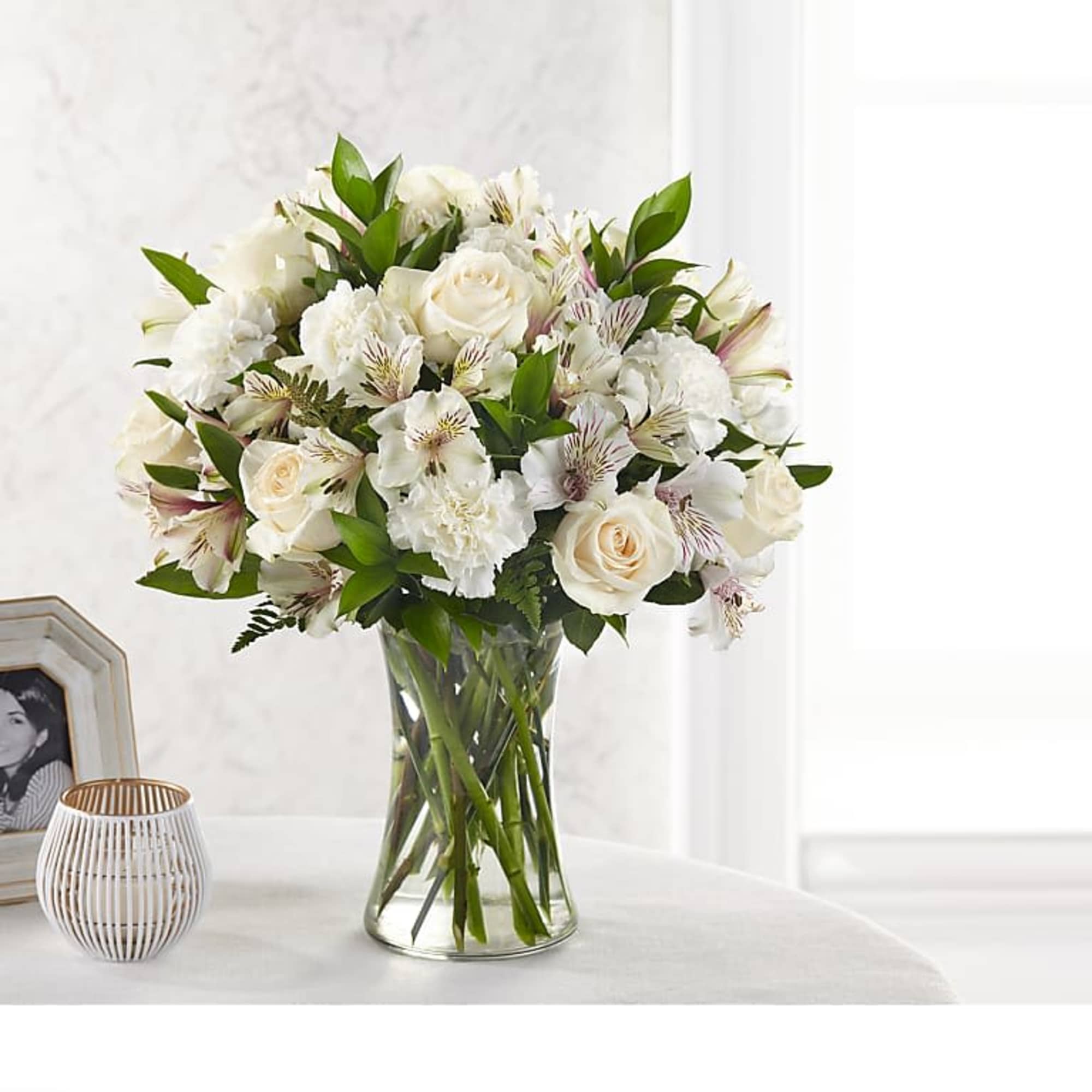 White roses and alstroemeria in a clear glass vase