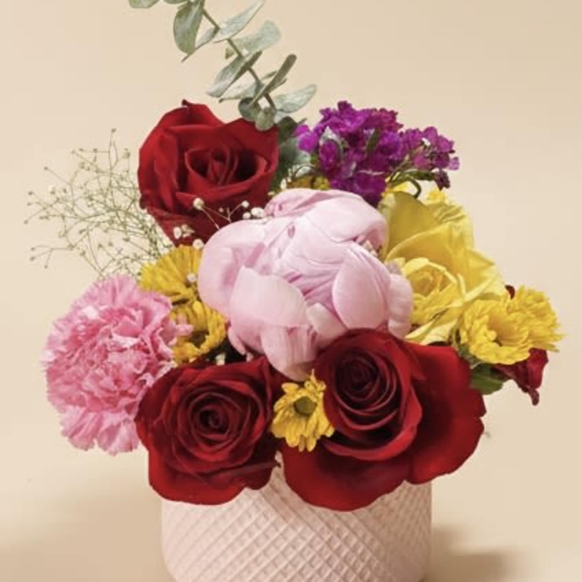A playful mix of deep red roses and soft pink blooms pops