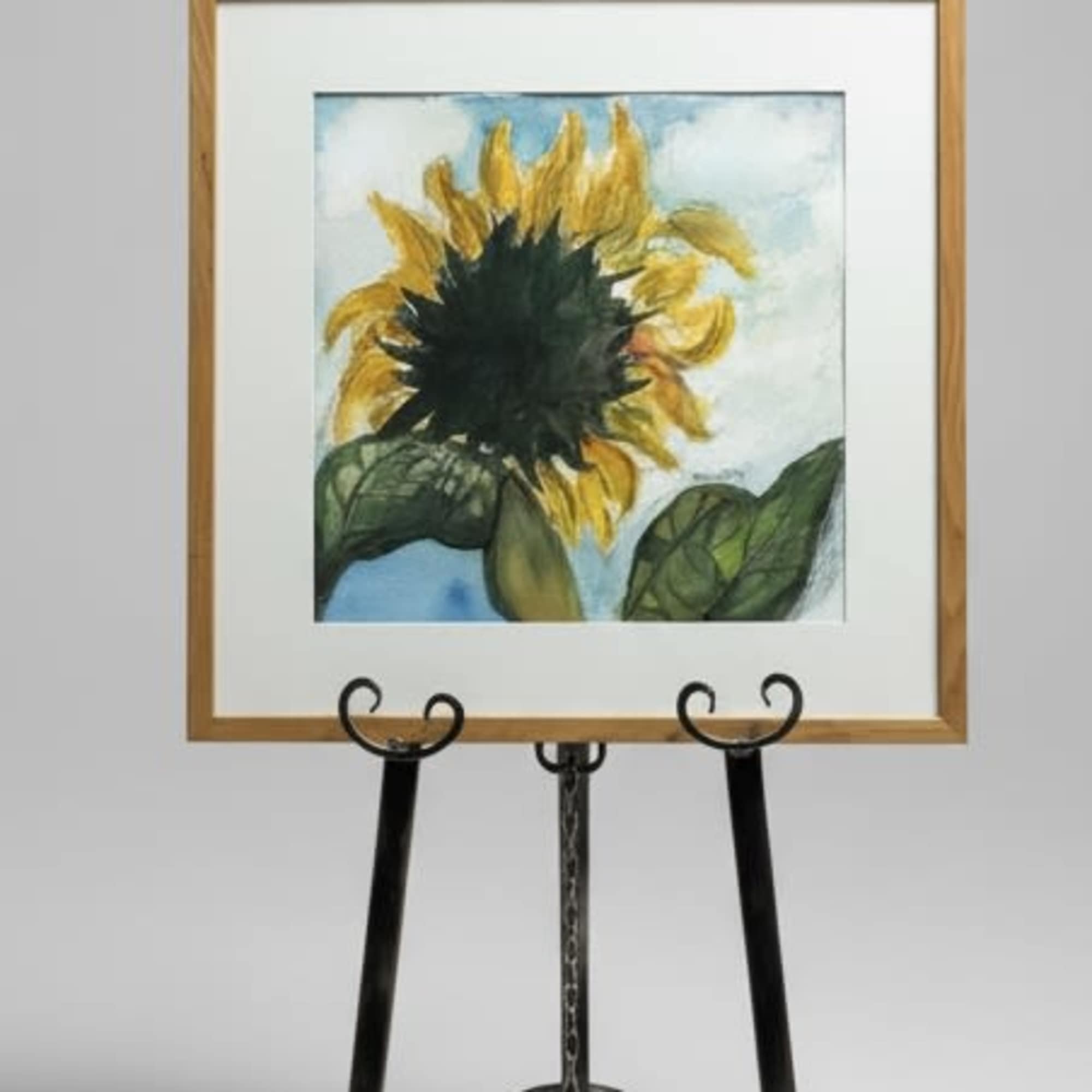 A single sunflower painted in warm, honeyed yellow takes center stage in