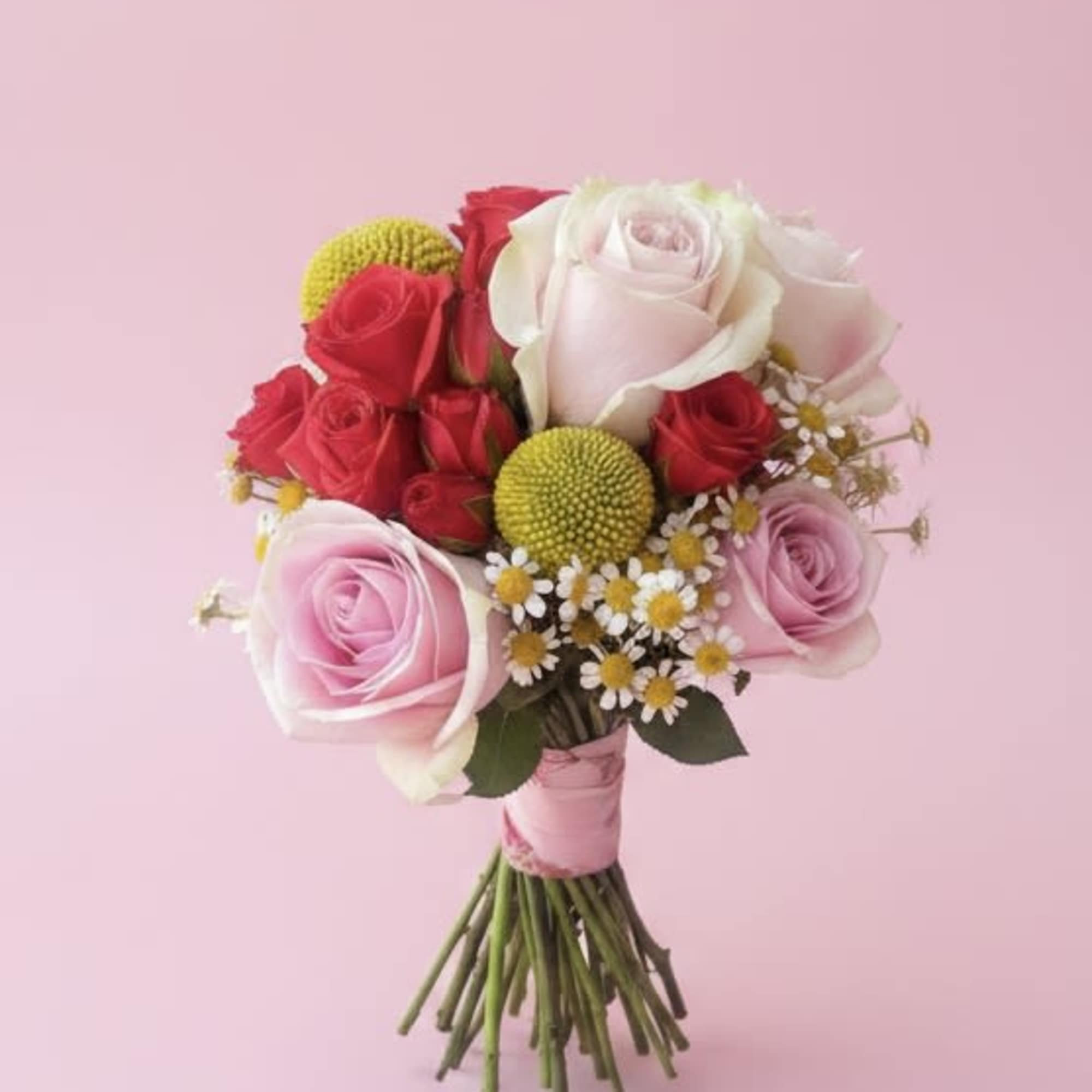 Soft pink and white roses layered with pops of bright red make, photo 2 of 2