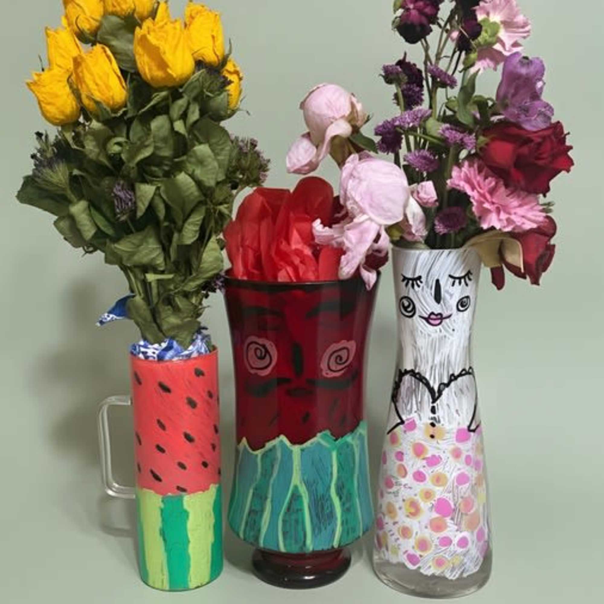 Three playful painted vessels hold a trio of cheerful bouquets designed to, photo 2 of 2