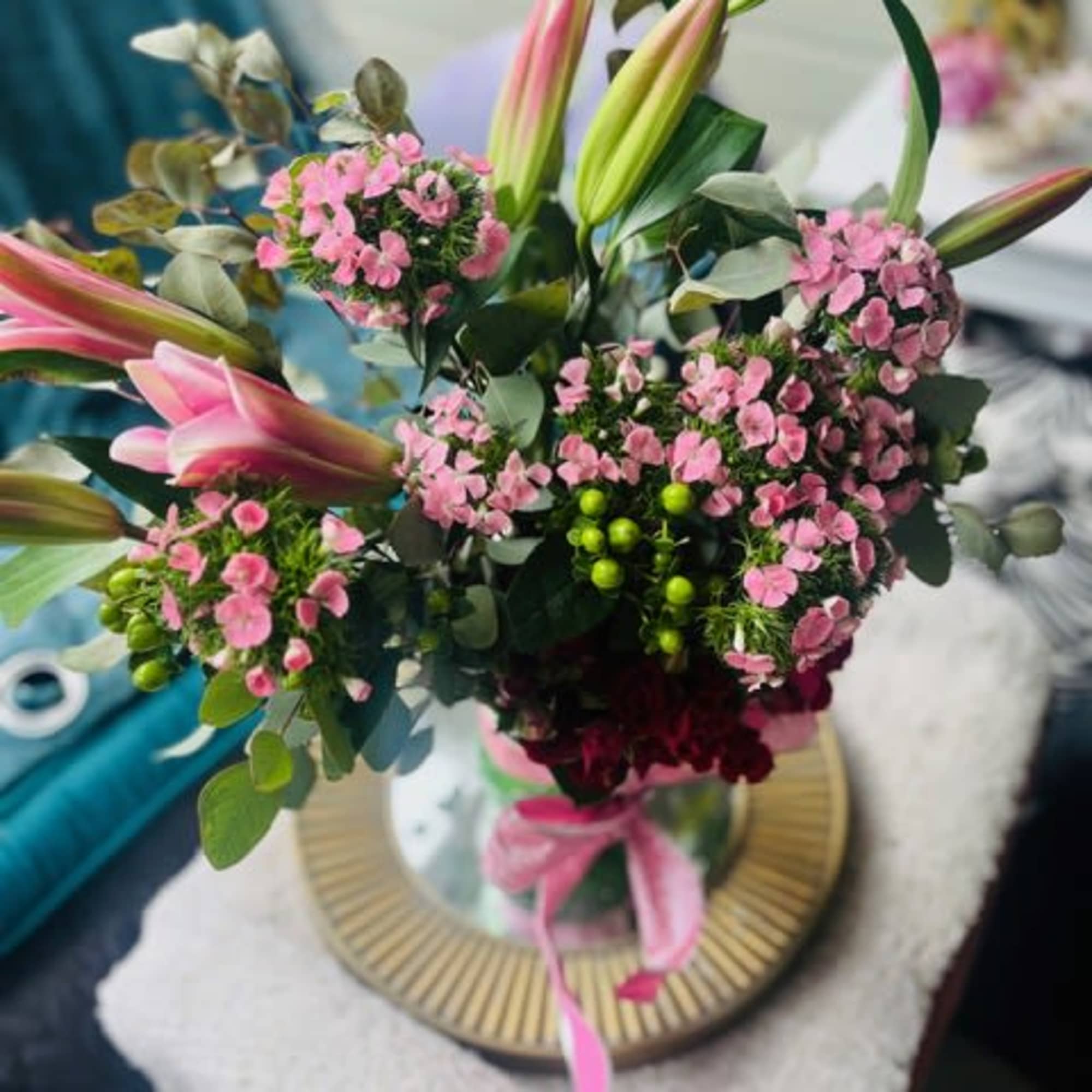 Soft pink lilies unfurl above a cloud of petite pink dianthus and