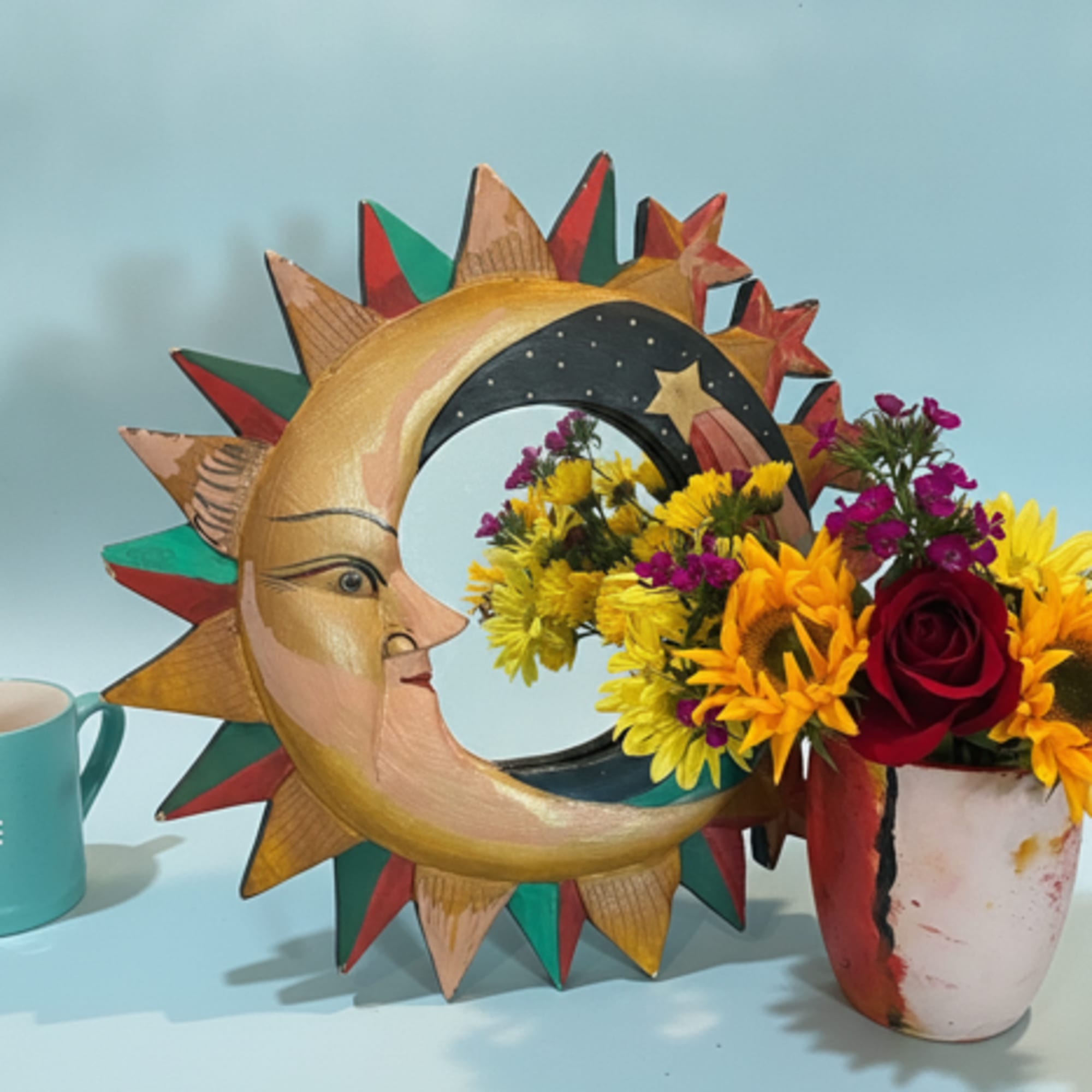 Bright, folk‑art charm meets a cheerful bouquet in this painted mirror and