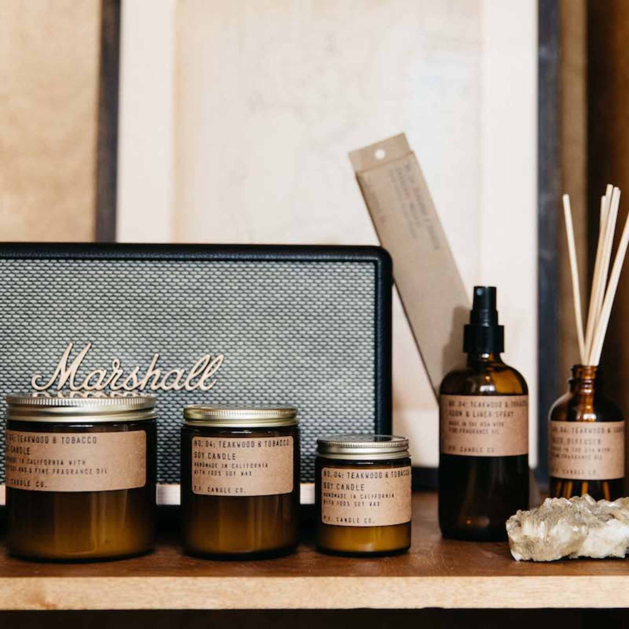 Assorted candles and reed diffuser bottles on a shelf