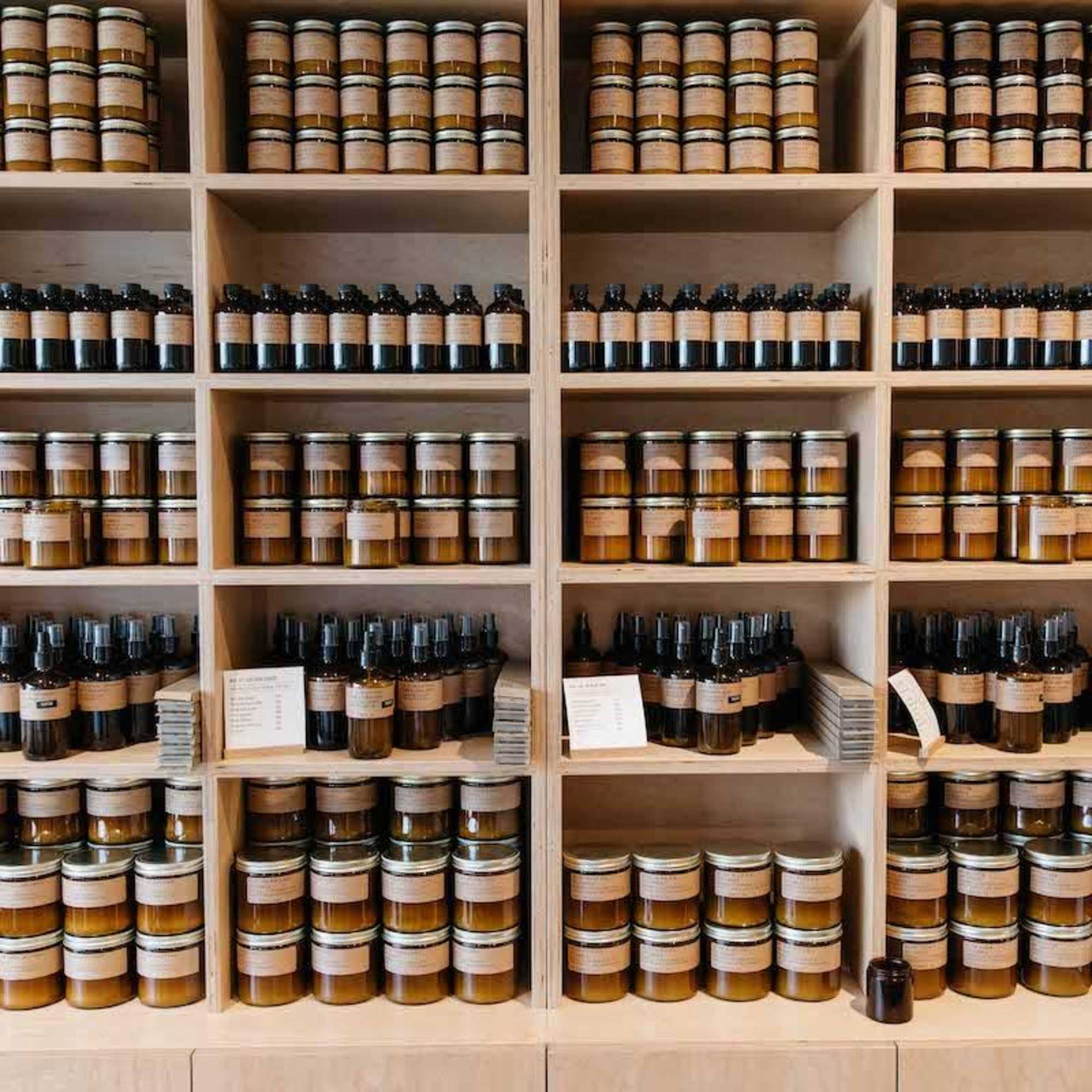 Shelves filled with rows of amber jars and dark bottles