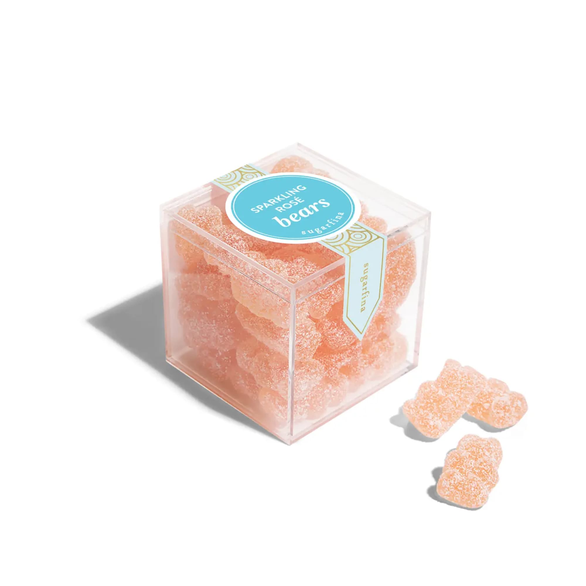 Clear cube of peach gummy bears with a few pieces outside