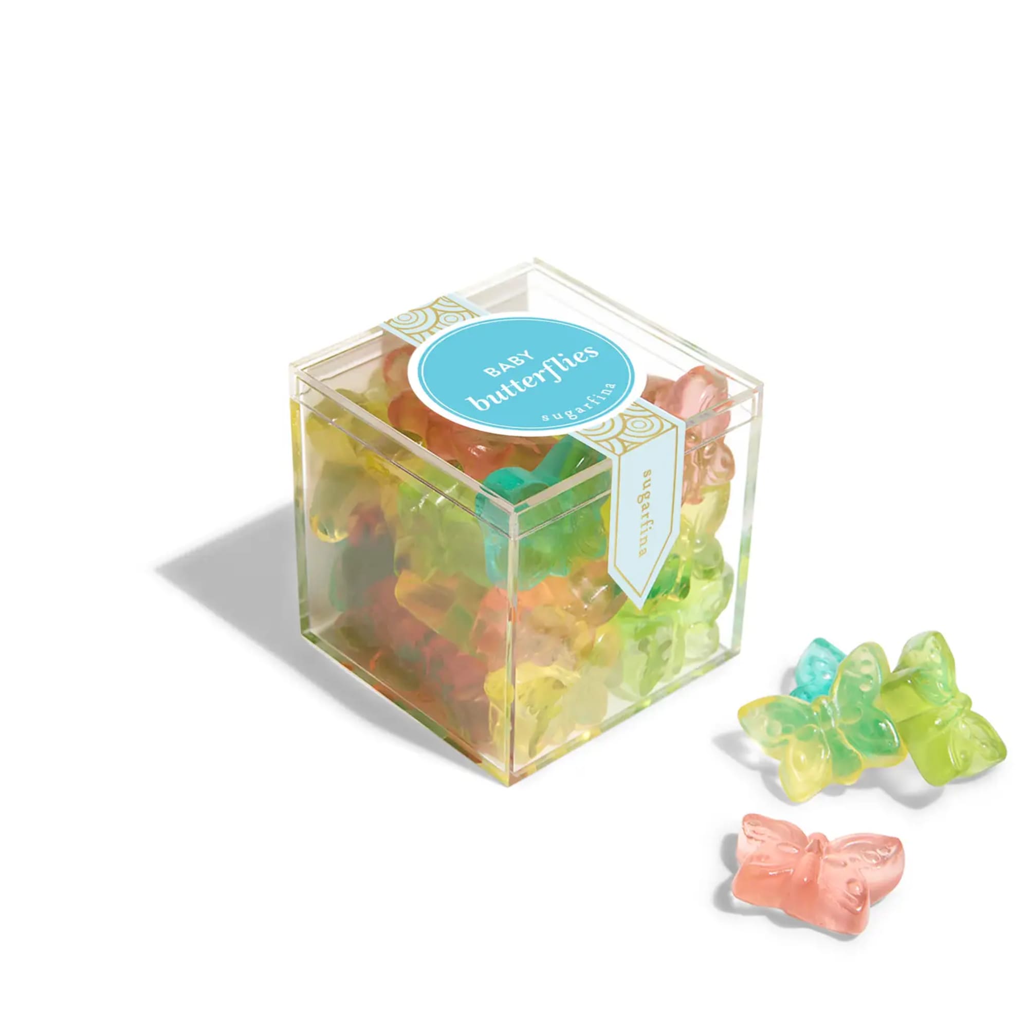 Clear box of colorful butterfly-shaped candies with a few pieces beside it
