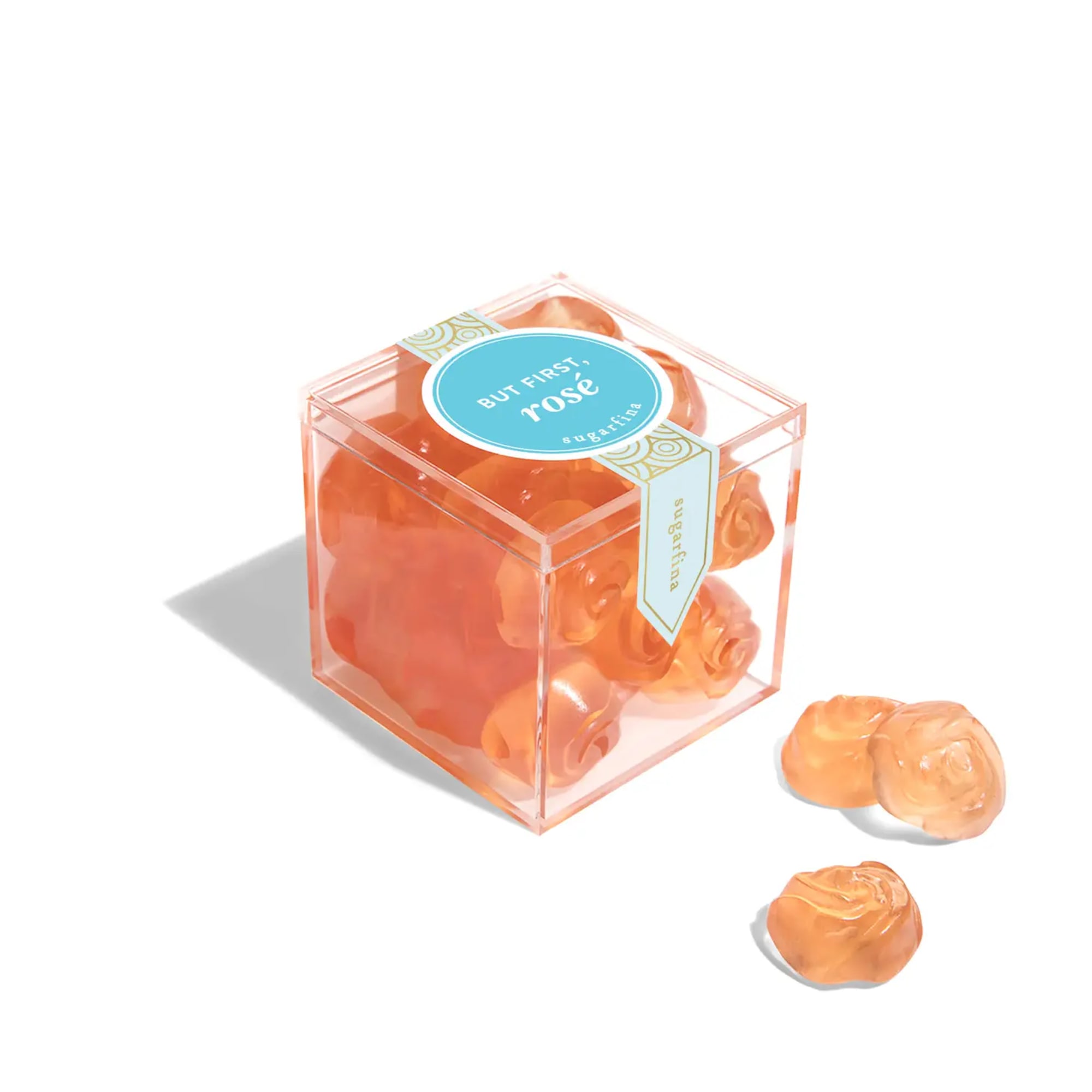 Clear cube box of orange rose-shaped candies