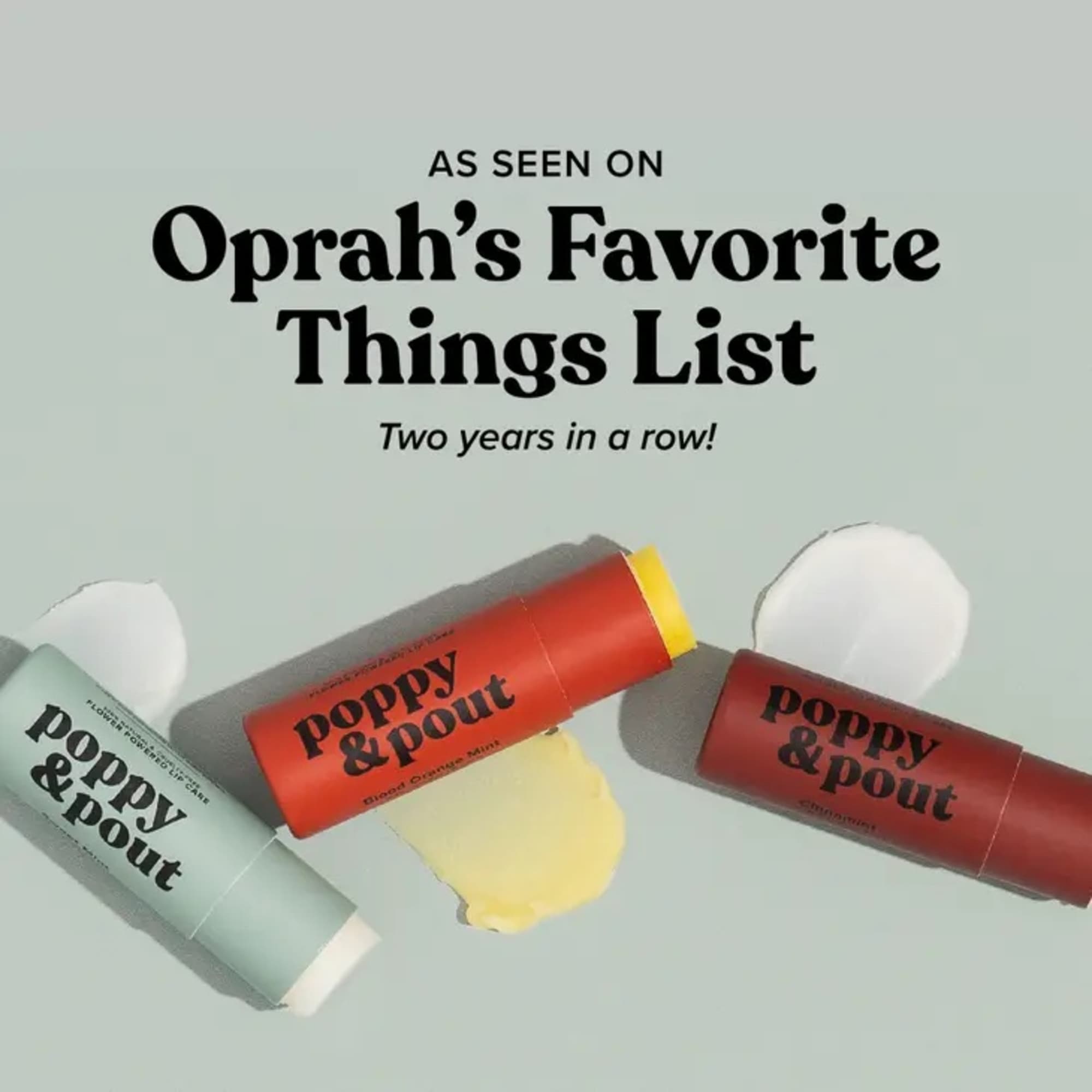 Three colorful poppy & pout lip balm tubes with text on a pale background