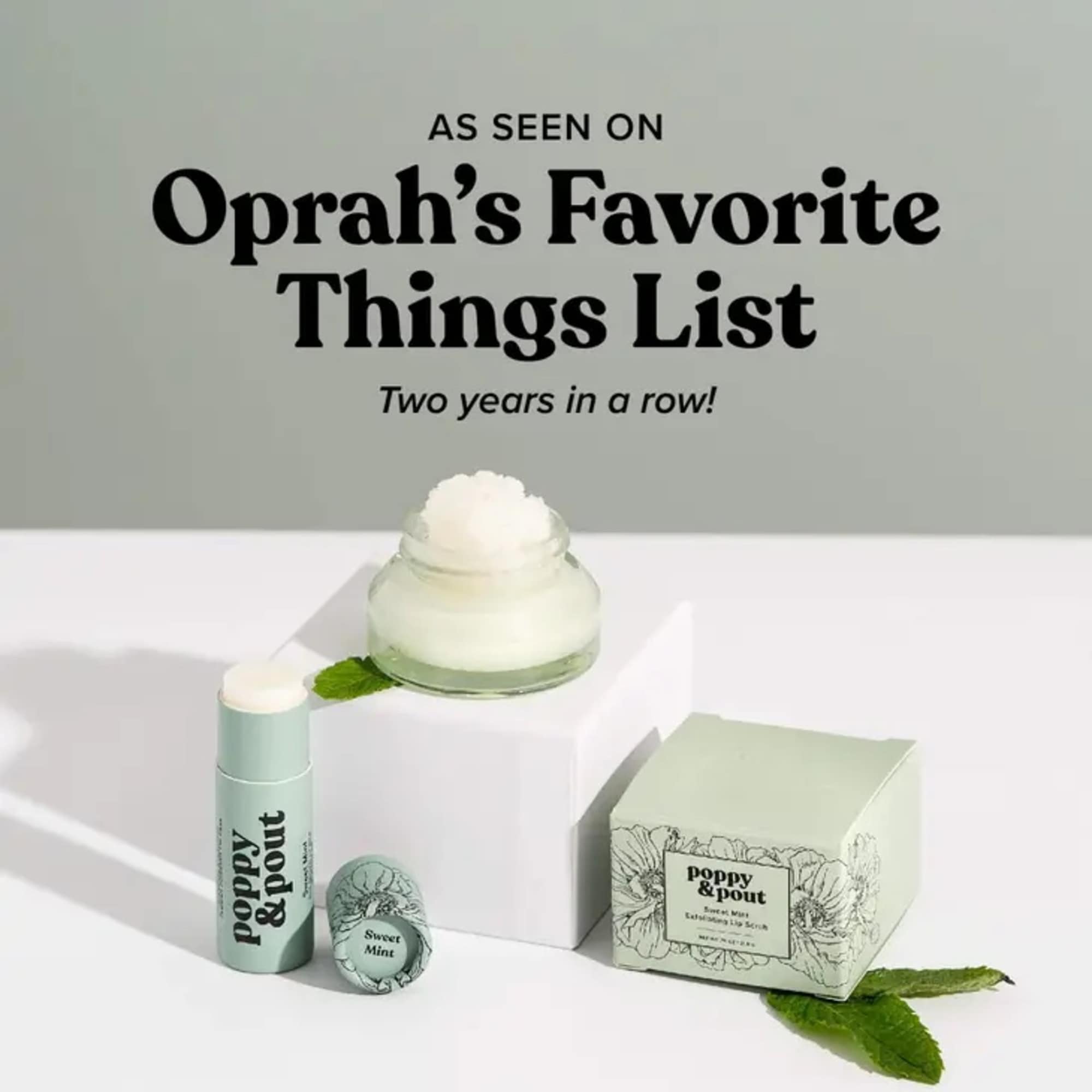 Mint-green skincare products with a white cream jar and floral box packaging.