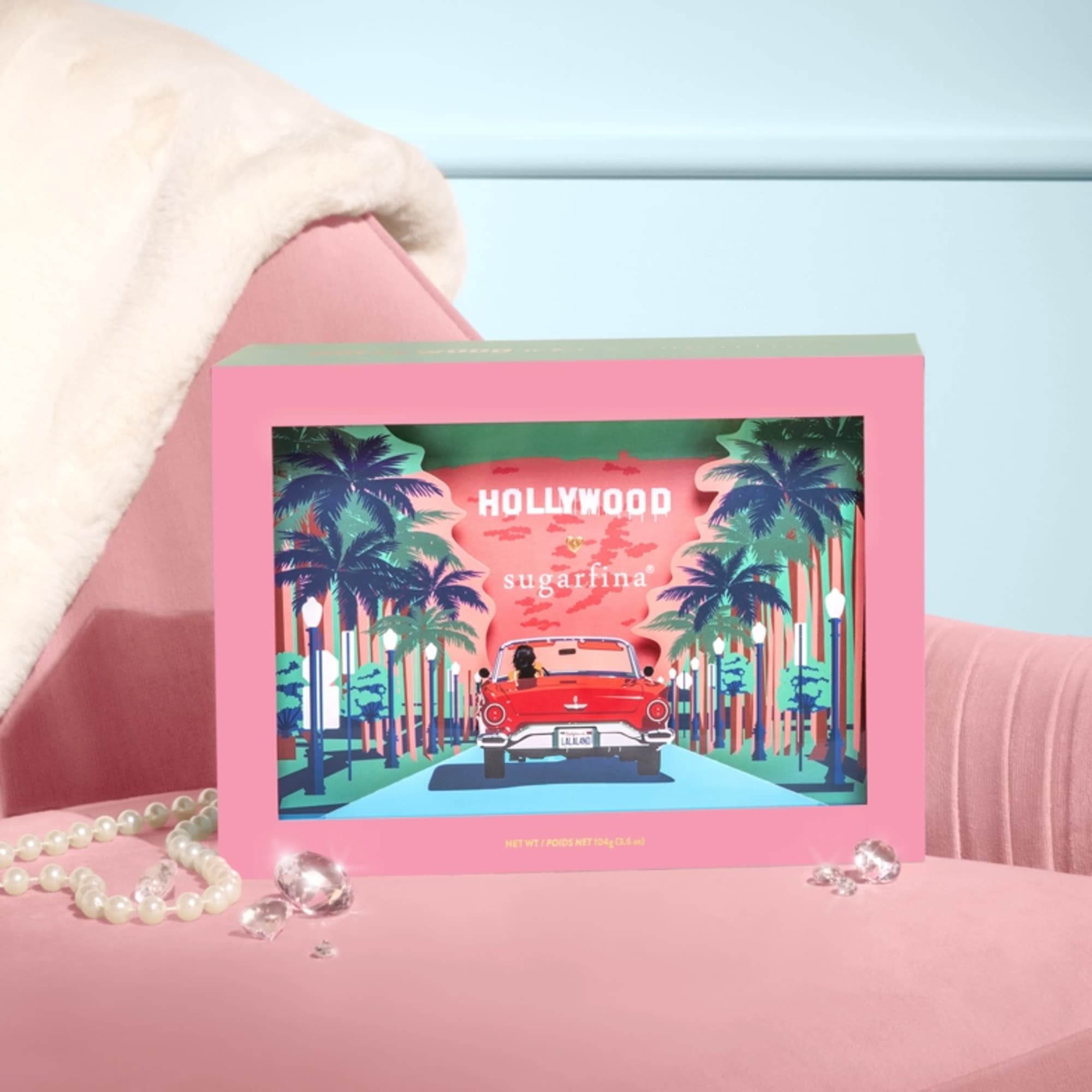 Pink Sugarfina candy box with a Hollywood-themed illustration