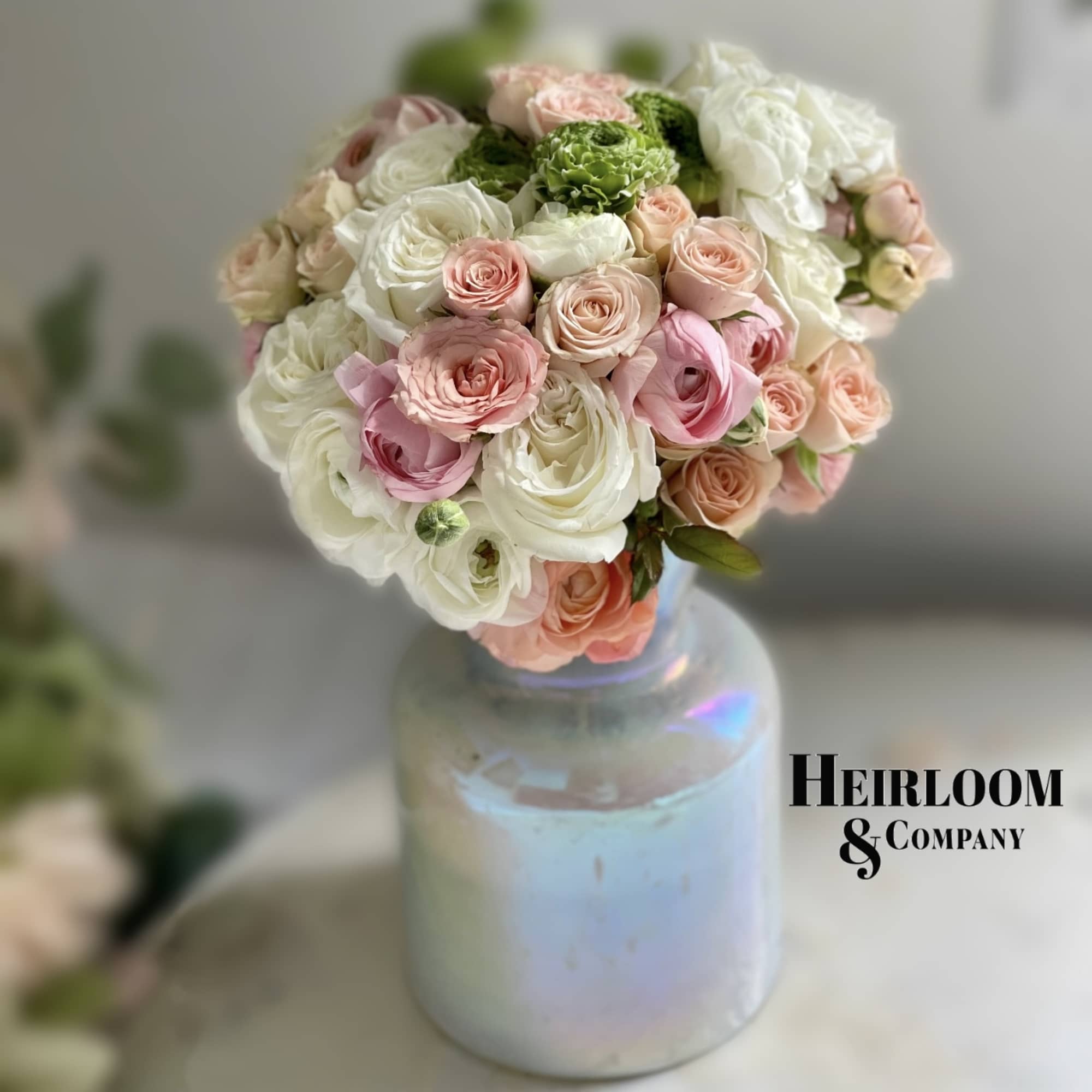 Bouquet of pink and white roses in a iridescent glass vase