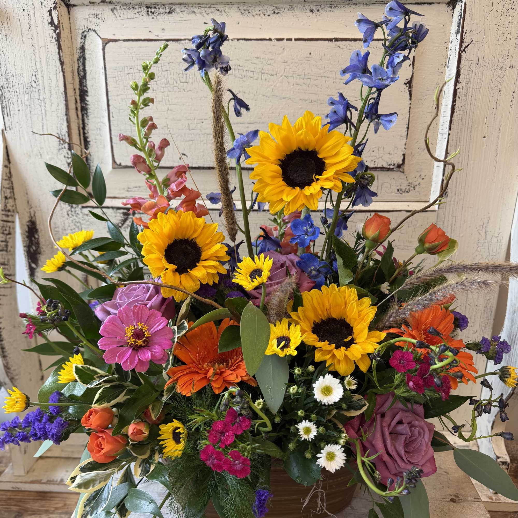 Sunflowers are the star of this rustic design in a metal pot