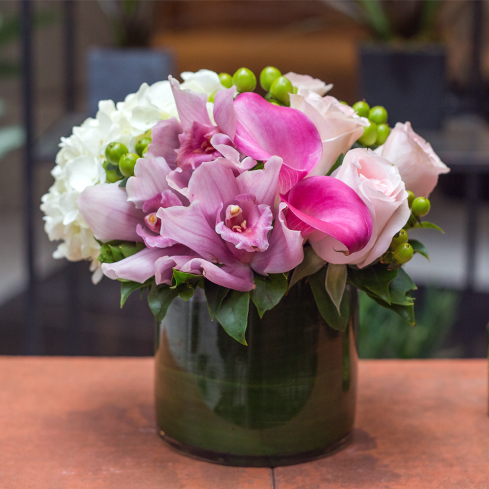 Pink and white floral arrangement in a glass vase