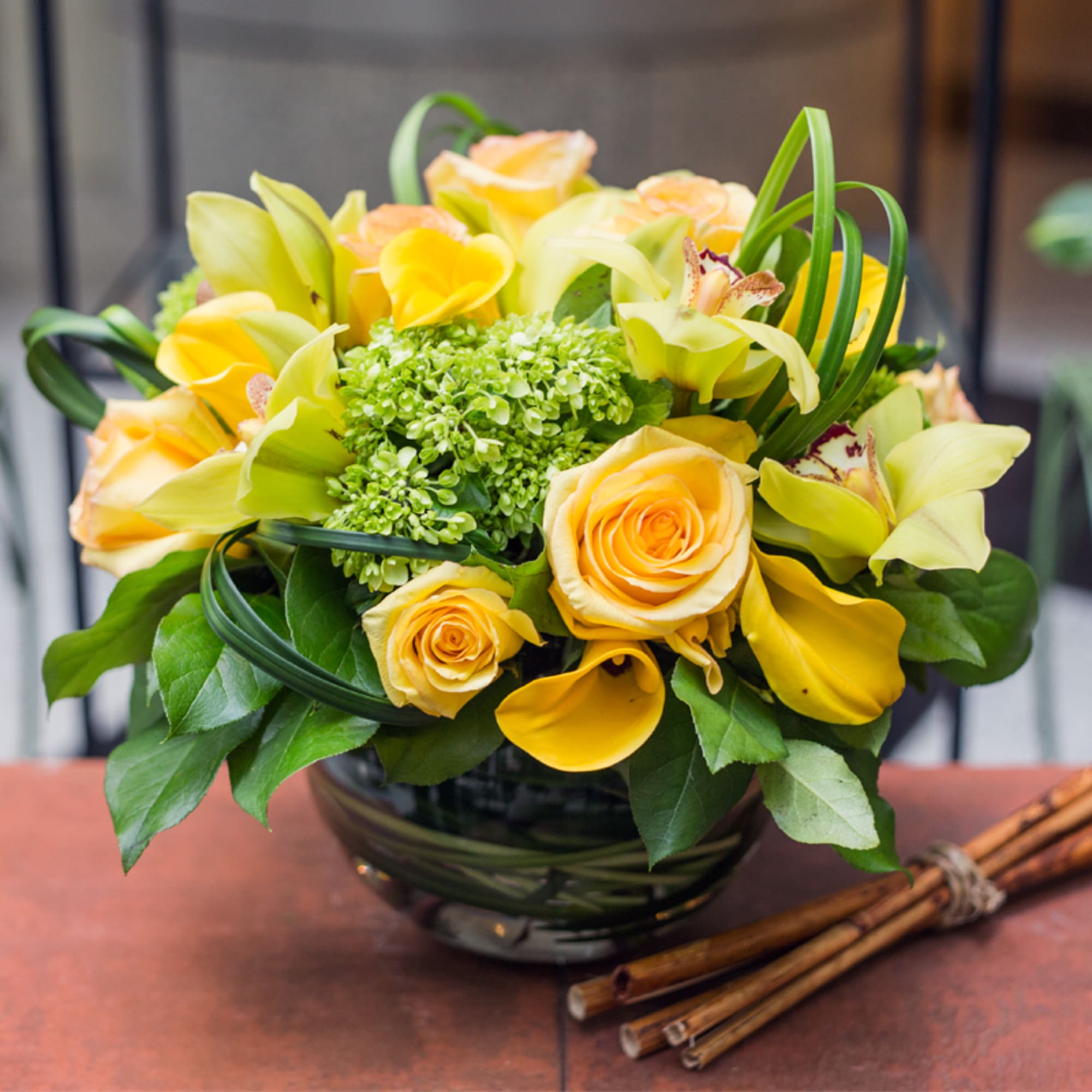 Yellow roses and calla lilies in a glass vase, photo 2 of 2
