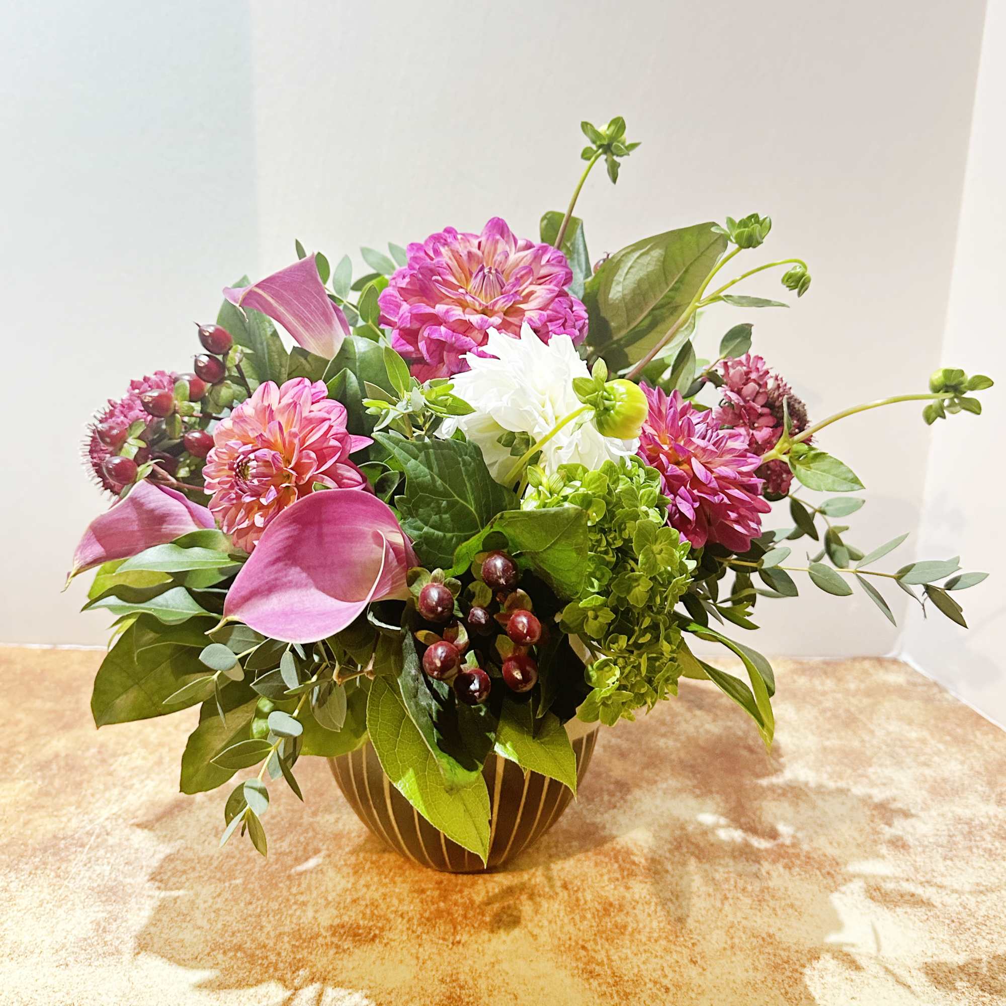 This arrangement is presented in a white/brown terracotta vase. It features dark, photo 2 of 2