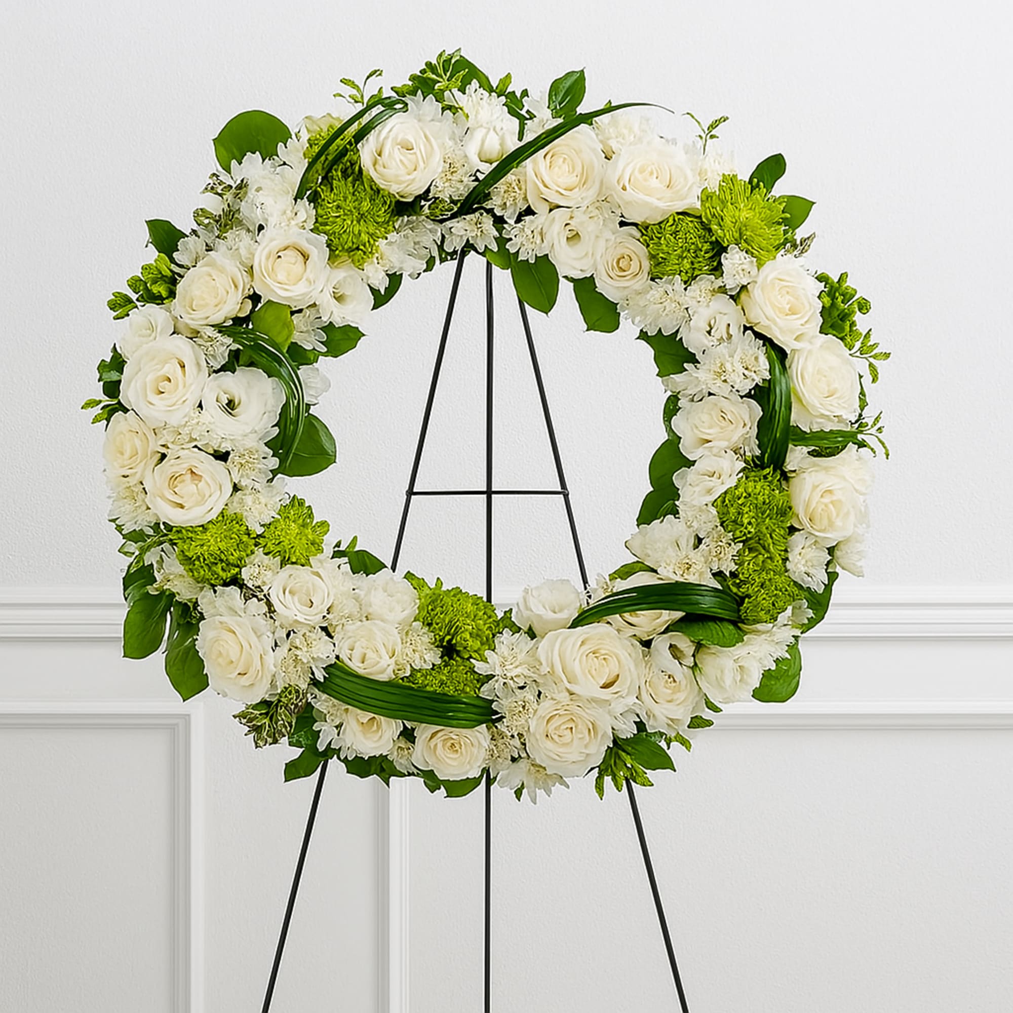 A beautiful white and green tribute wreath that calms, this easel arrangement