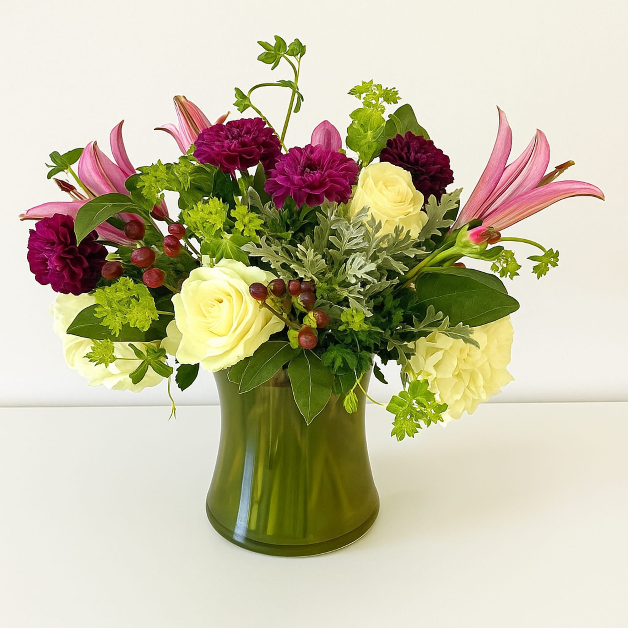 This arrangement is presented in a medium height clear glass vase. It