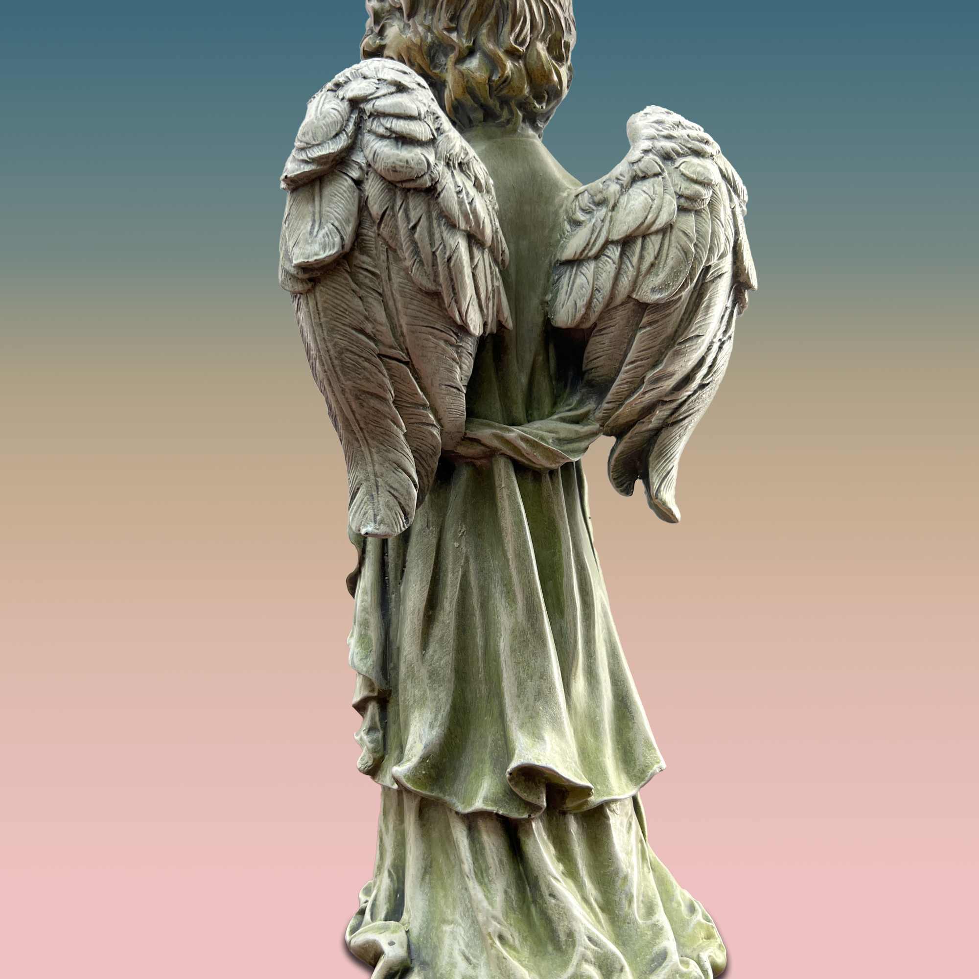 Stone angel statue with wings and a long robe