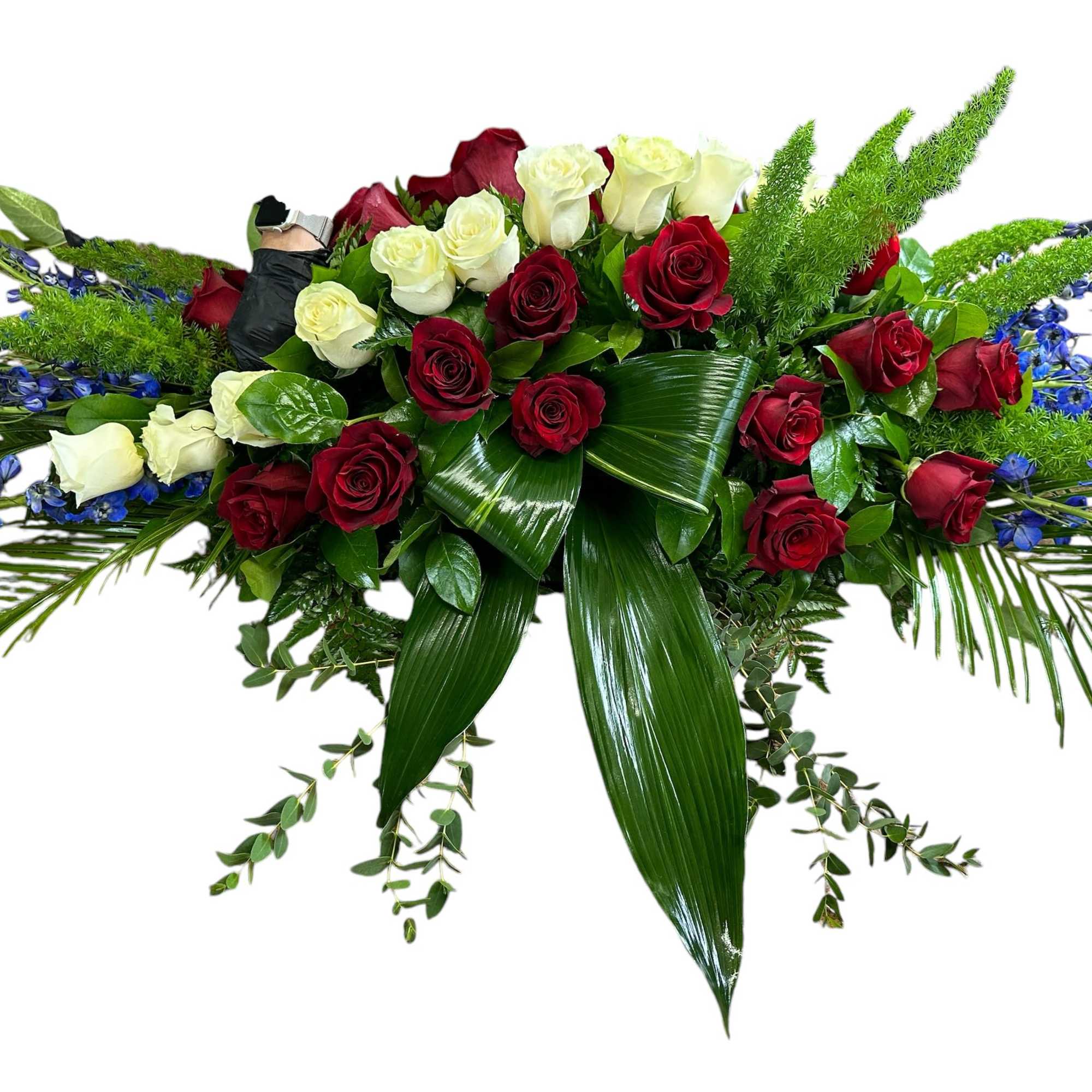Long floral spray of red and white roses with blue accents