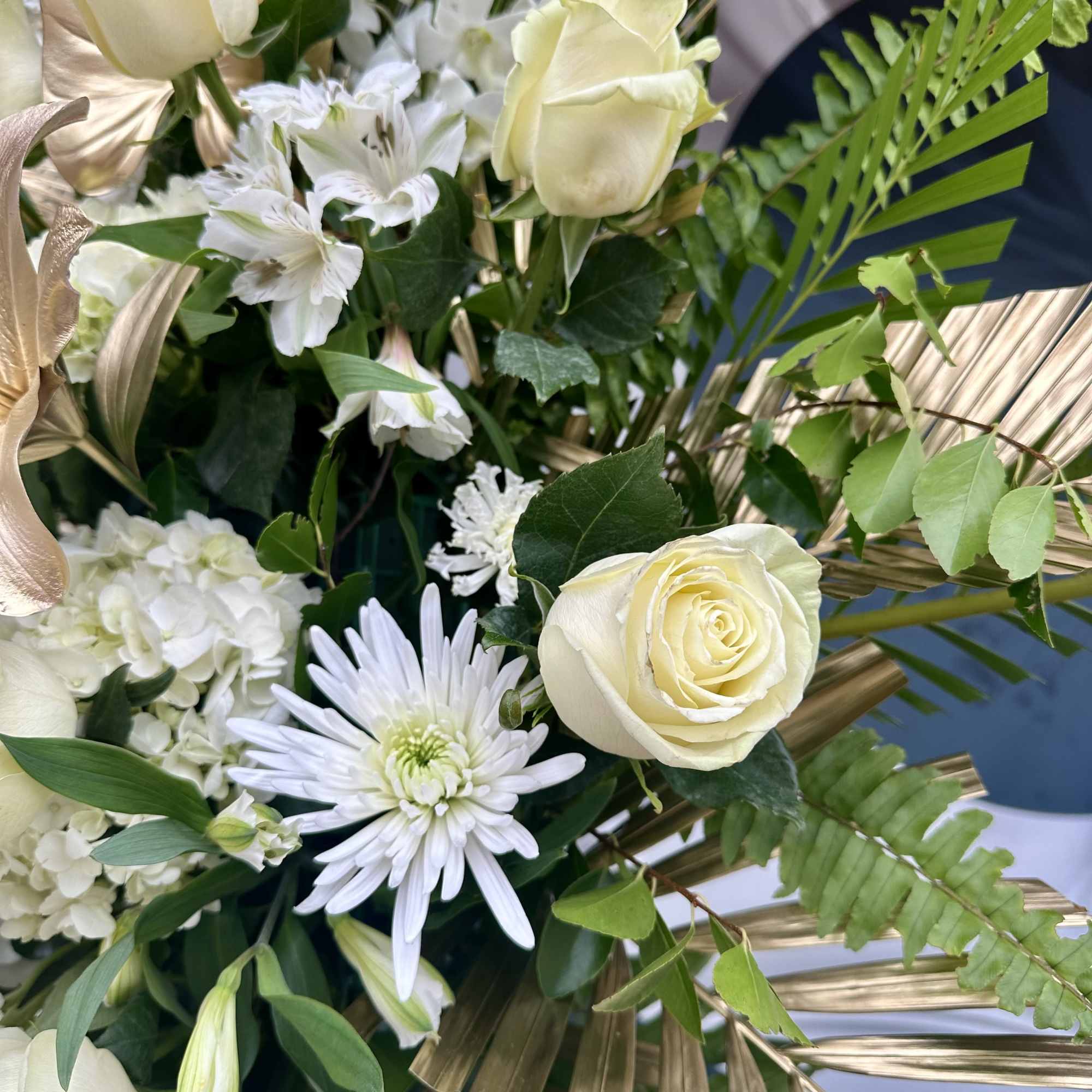 Cream roses and white blooms with gold palm fronds