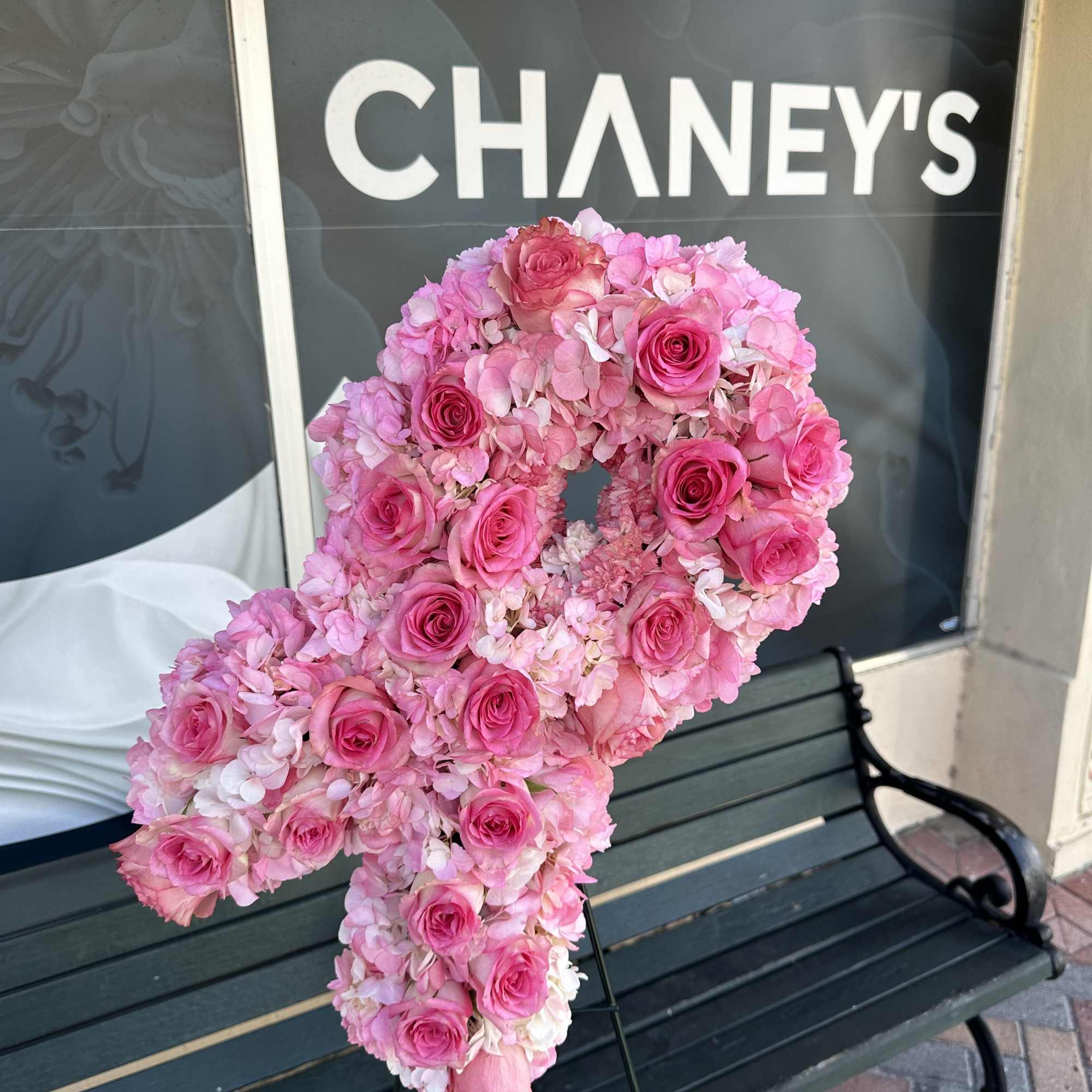 Pink rose and hydrangea floral number on a stand