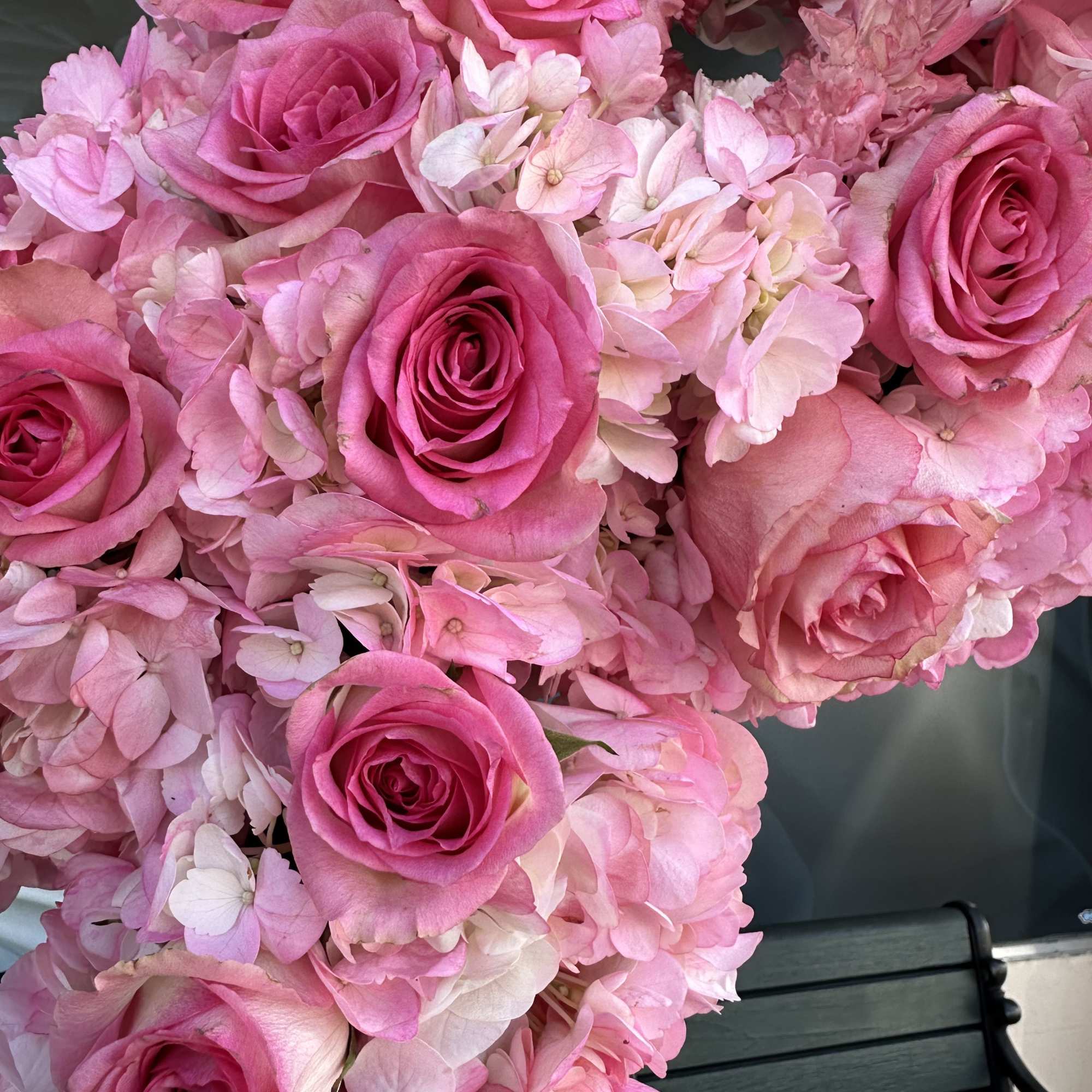 Pink roses clustered with pale pink hydrangea blooms