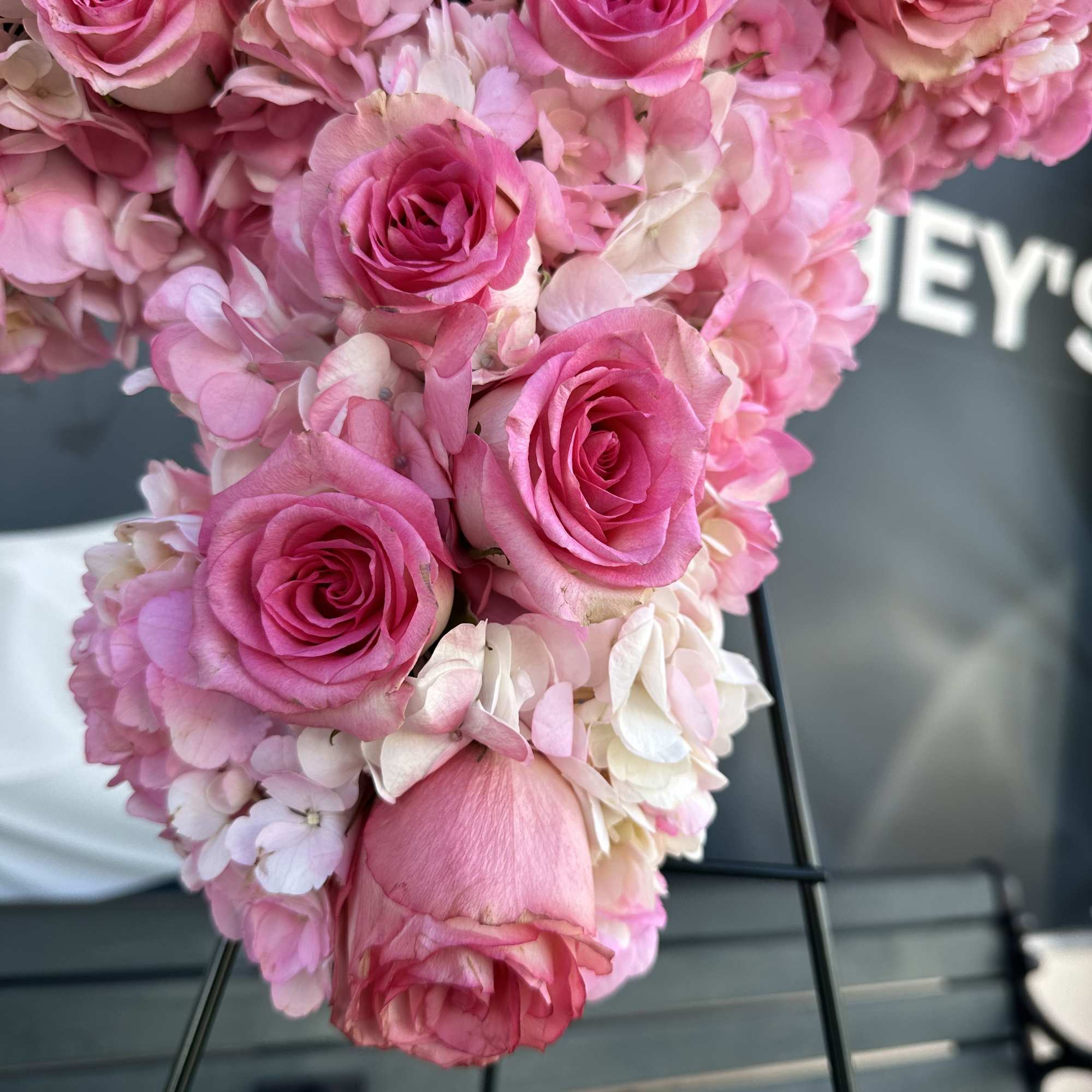 Pink roses clustered with pale pink hydrangeas in a heart-shaped arrangement