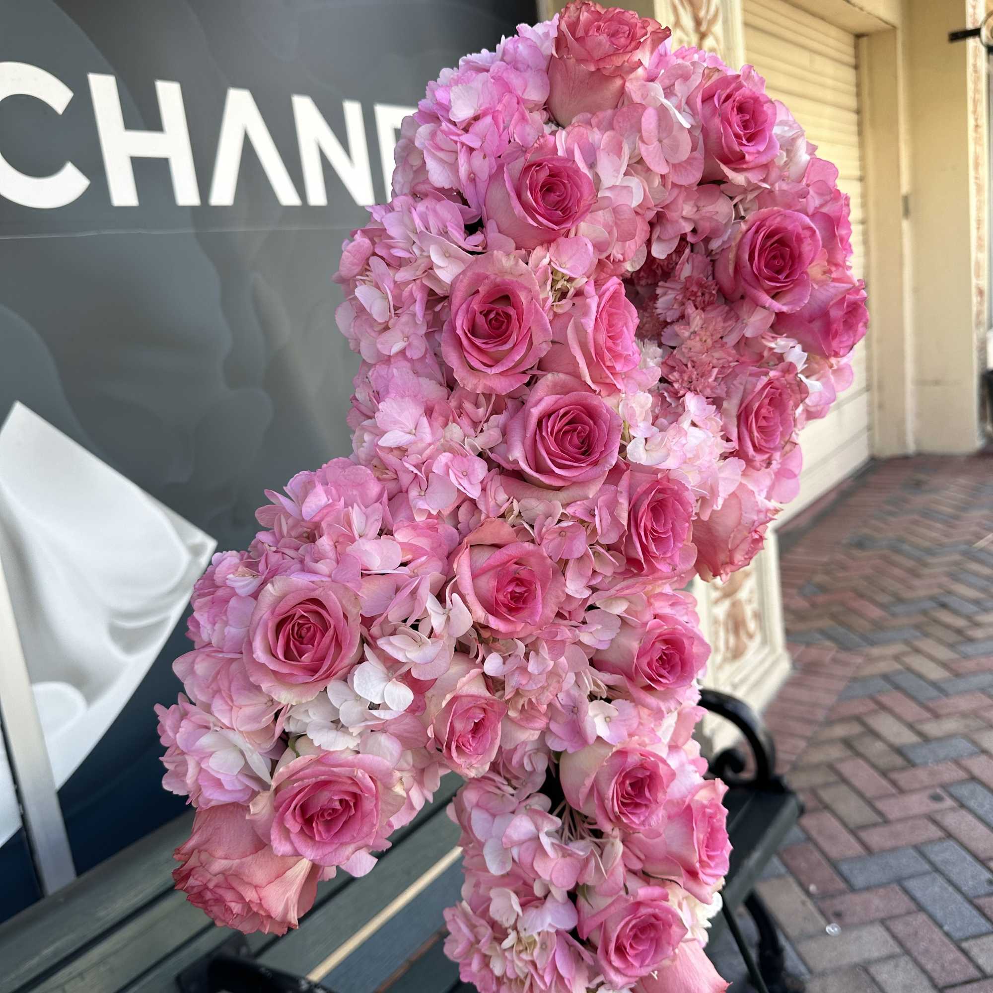 Pink rose and hydrangea floral arrangement shaped like a number