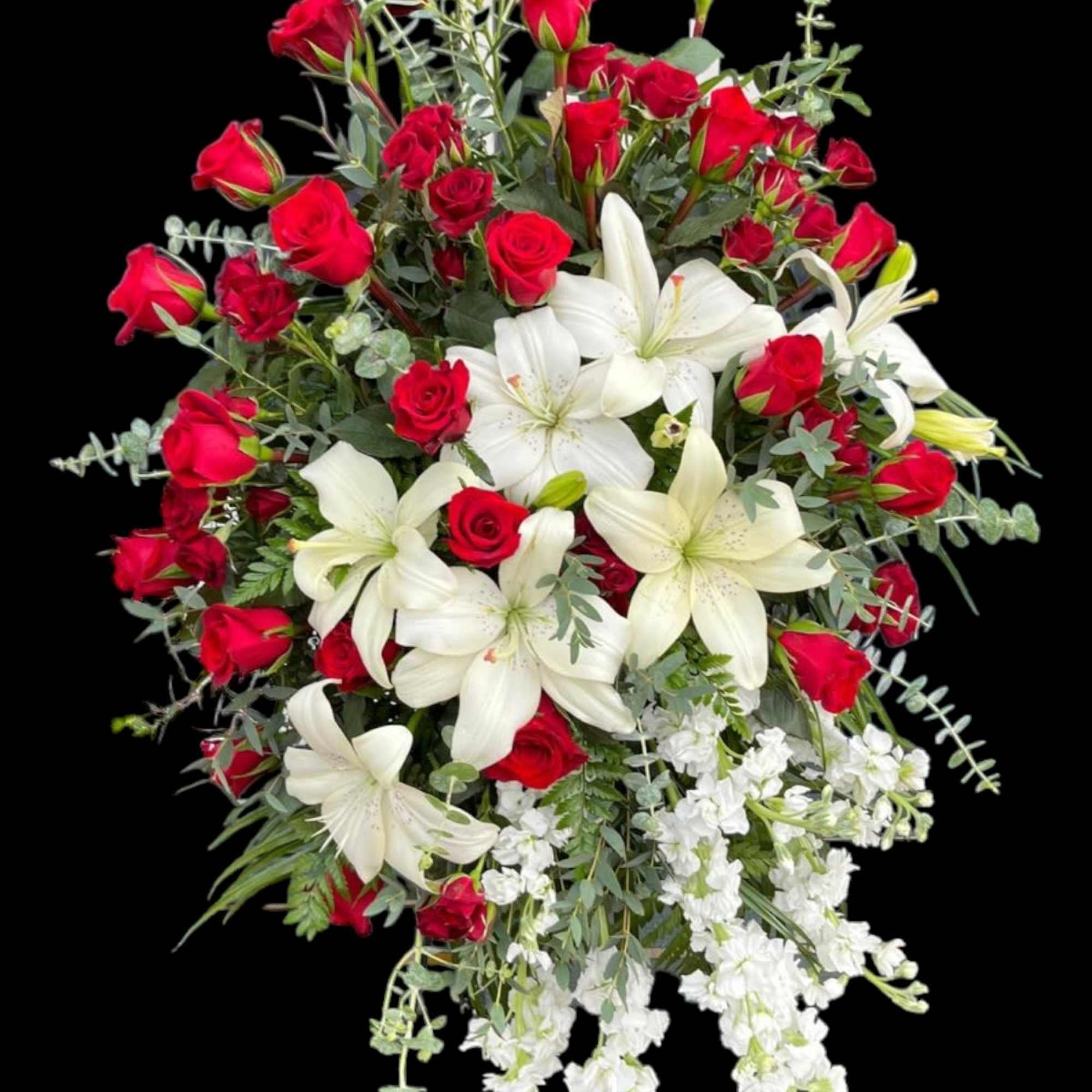 Red roses and white lilies arranged in a large bouquet