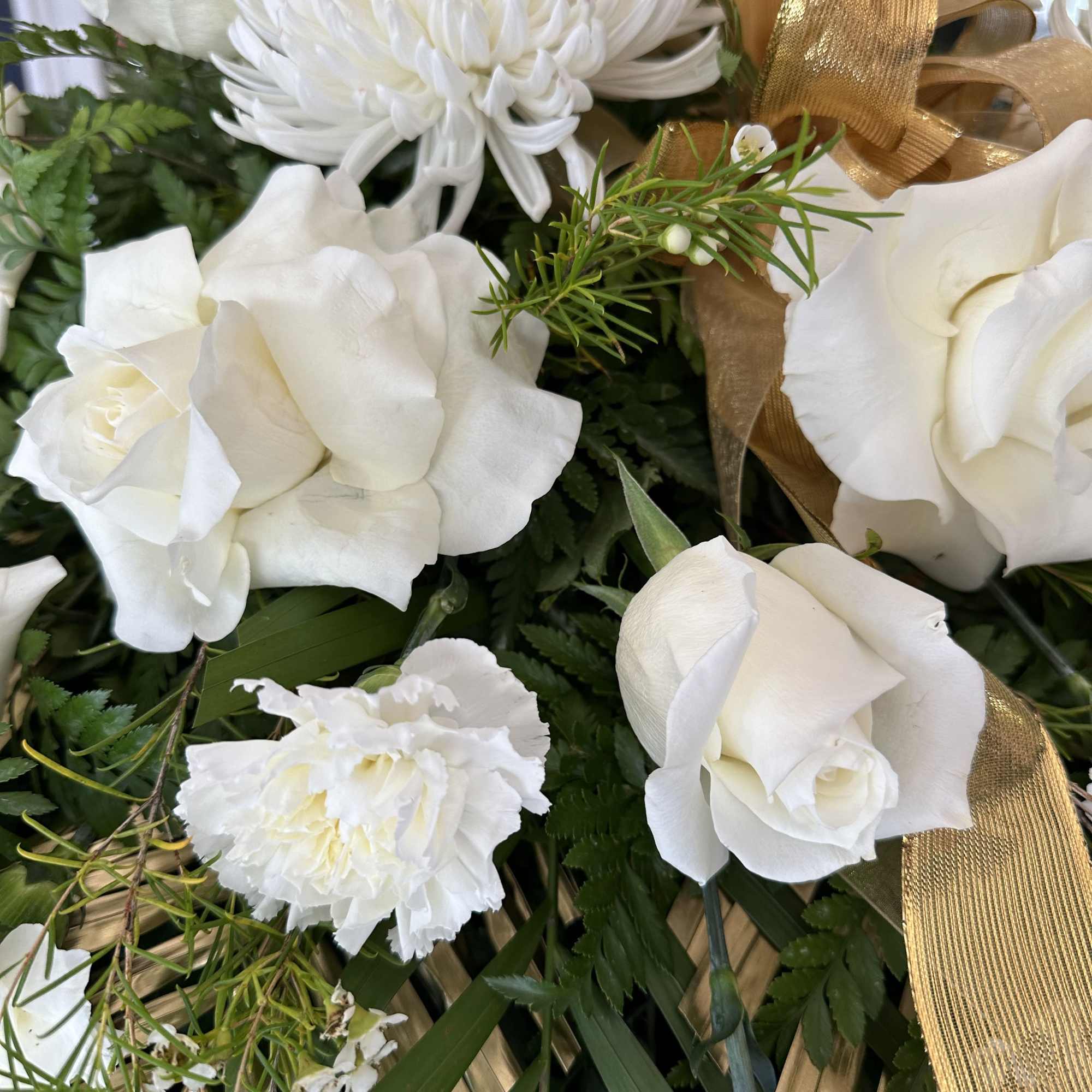 White roses and chrysanthemums with a gold ribbon