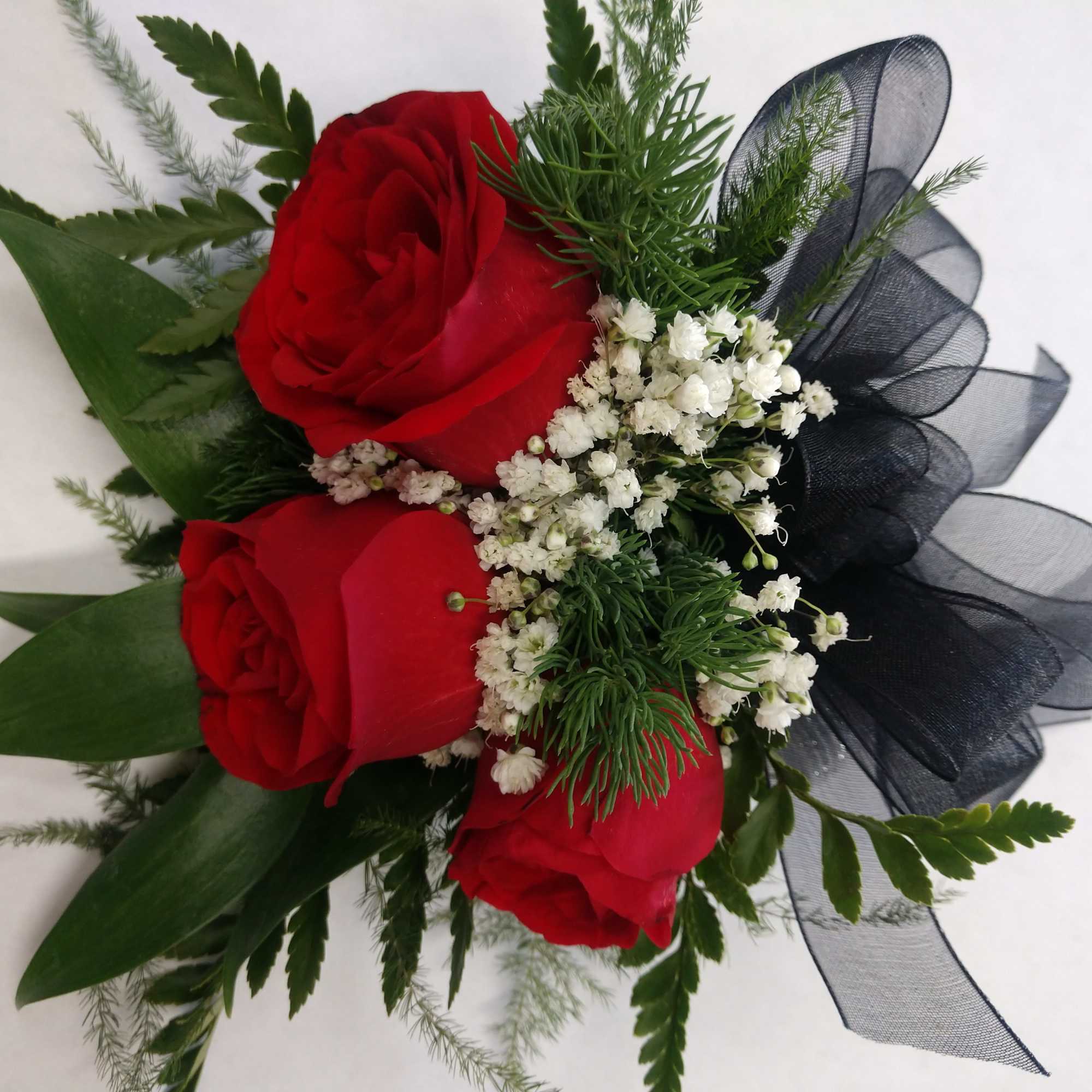 Three red roses with baby's breath and black ribbon