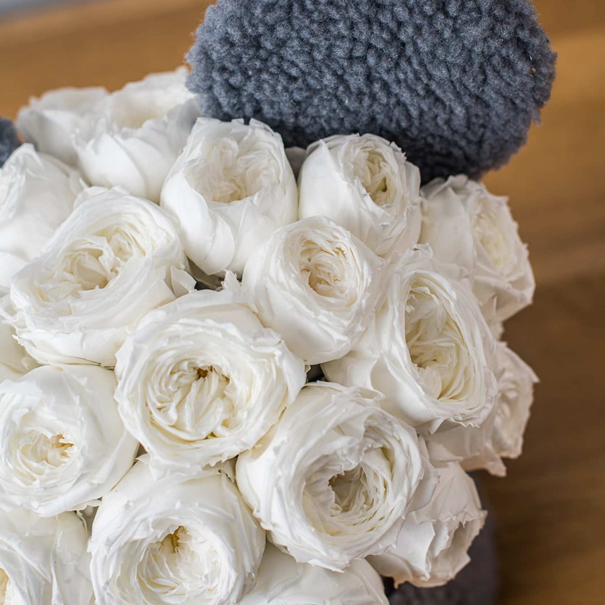 White ranunculus bouquet with a gray textured wrap
