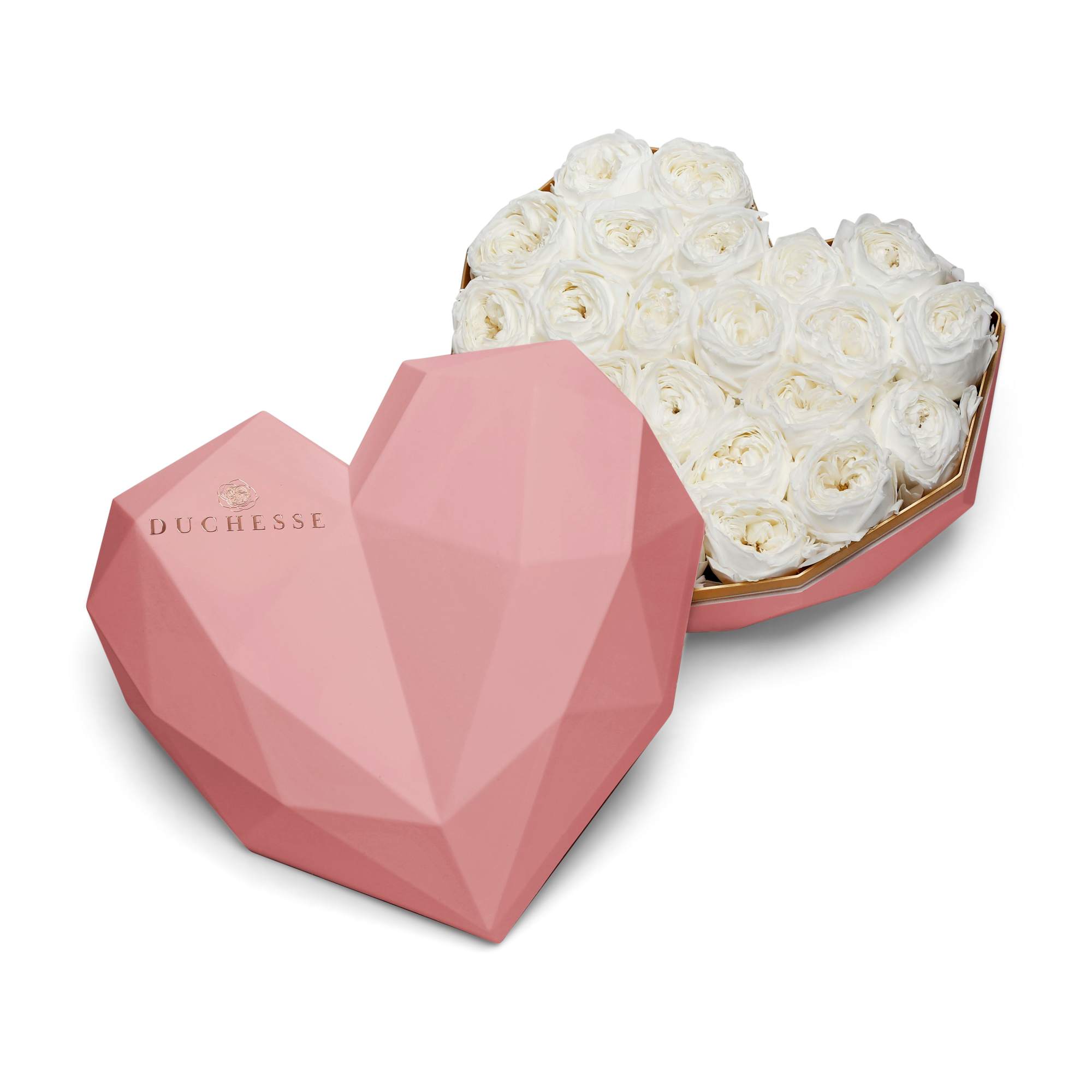 White roses in a pink heart-shaped box