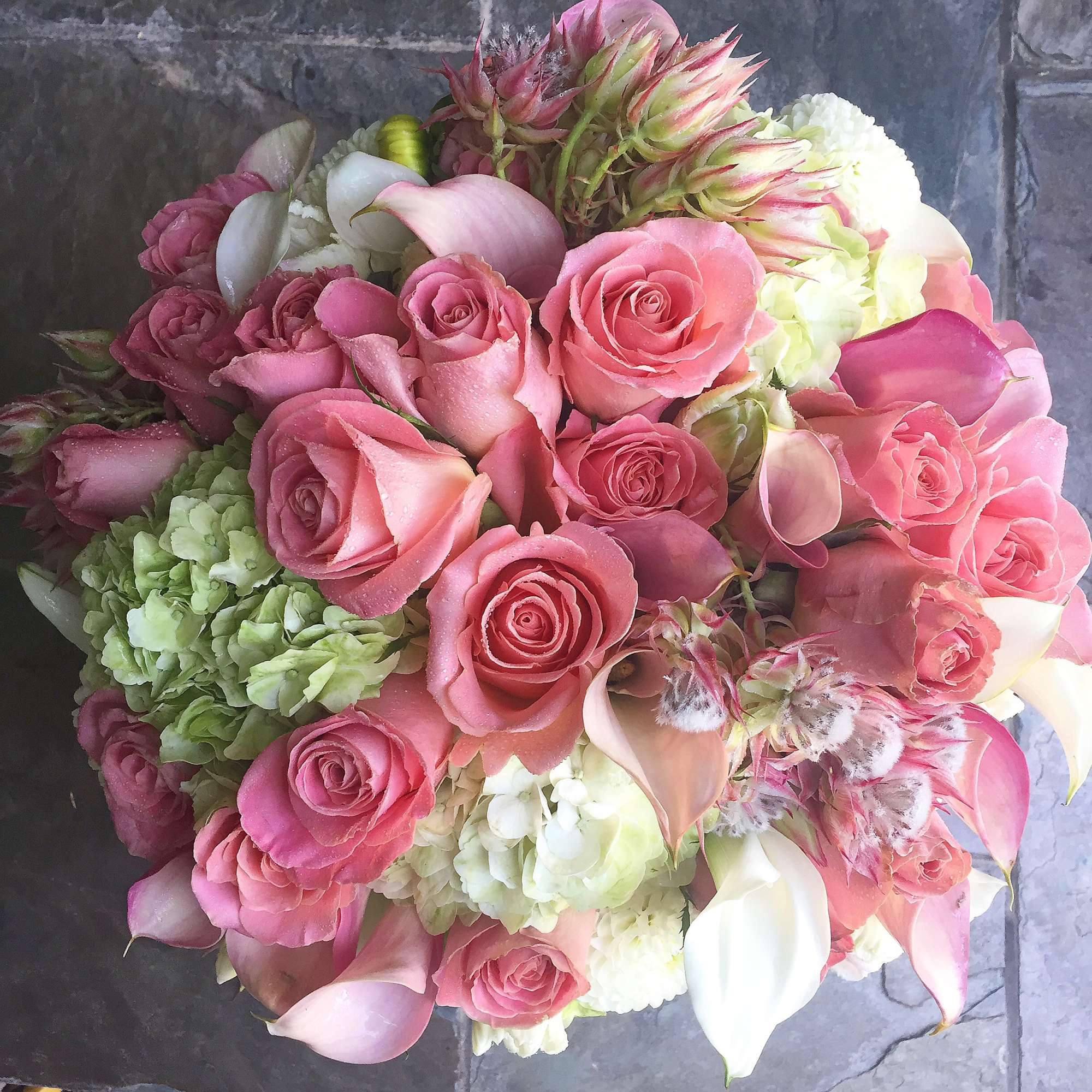 Pink roses and white calla lilies in a round bouquet