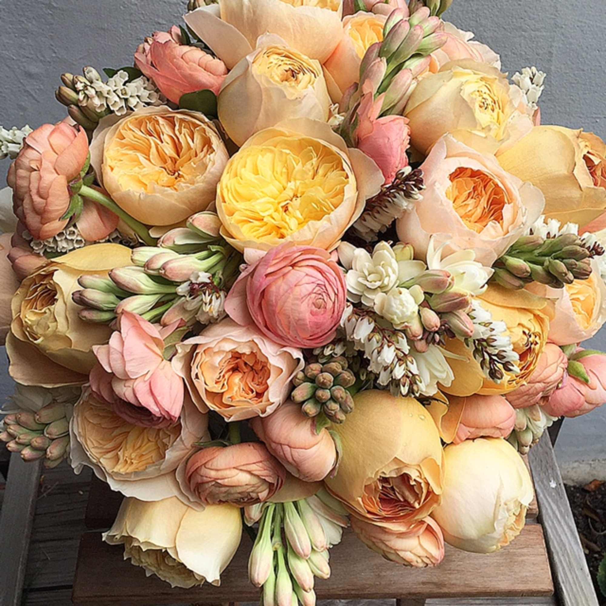 Bouquet of peach, pink, and cream tulips with small white accents