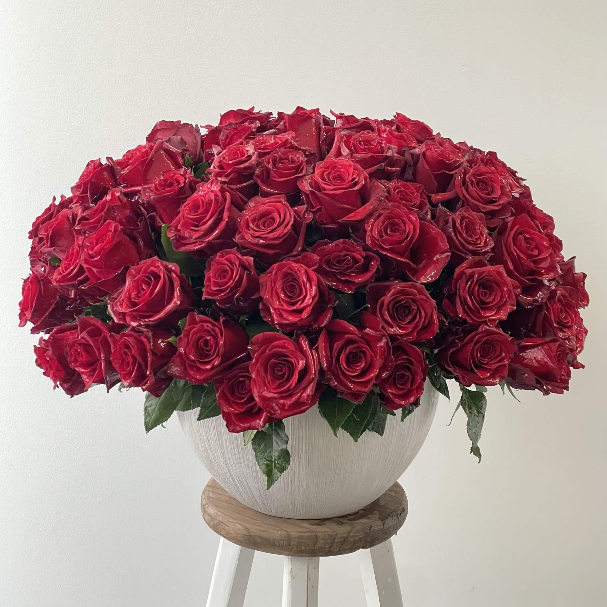 Large bouquet of red roses in a white vase