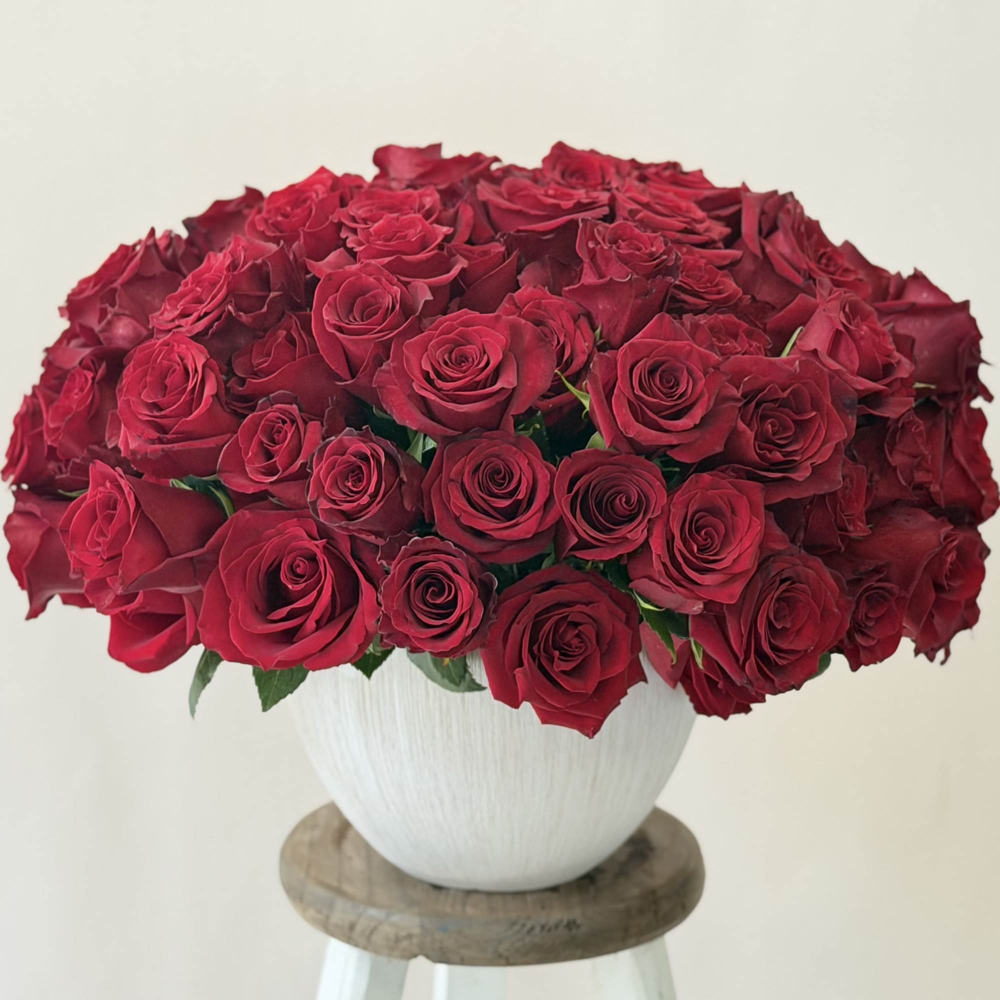 Large bouquet of red roses in a white vase