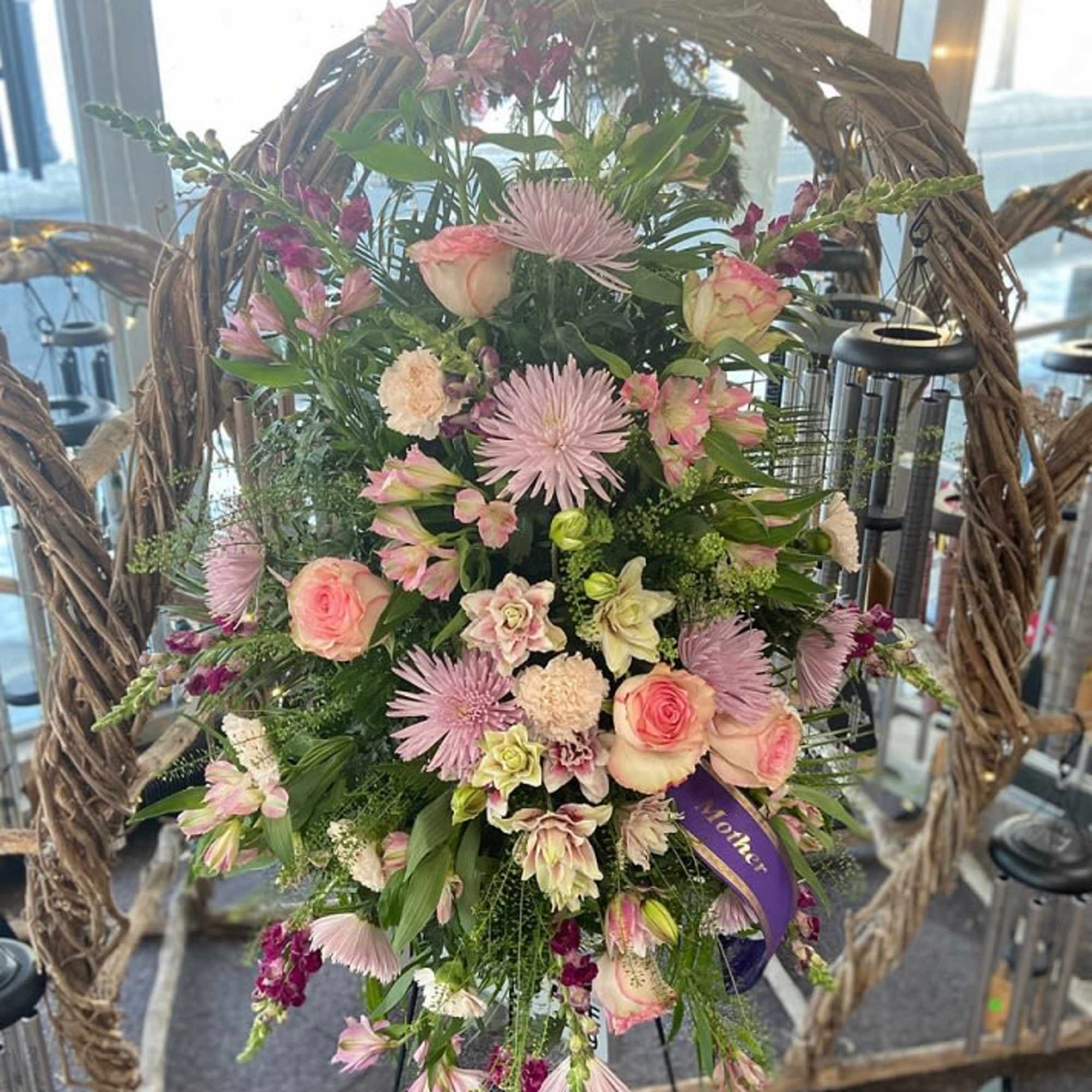 Standing heart wreath with pink and lavender flowers and a purple Mother ribbon