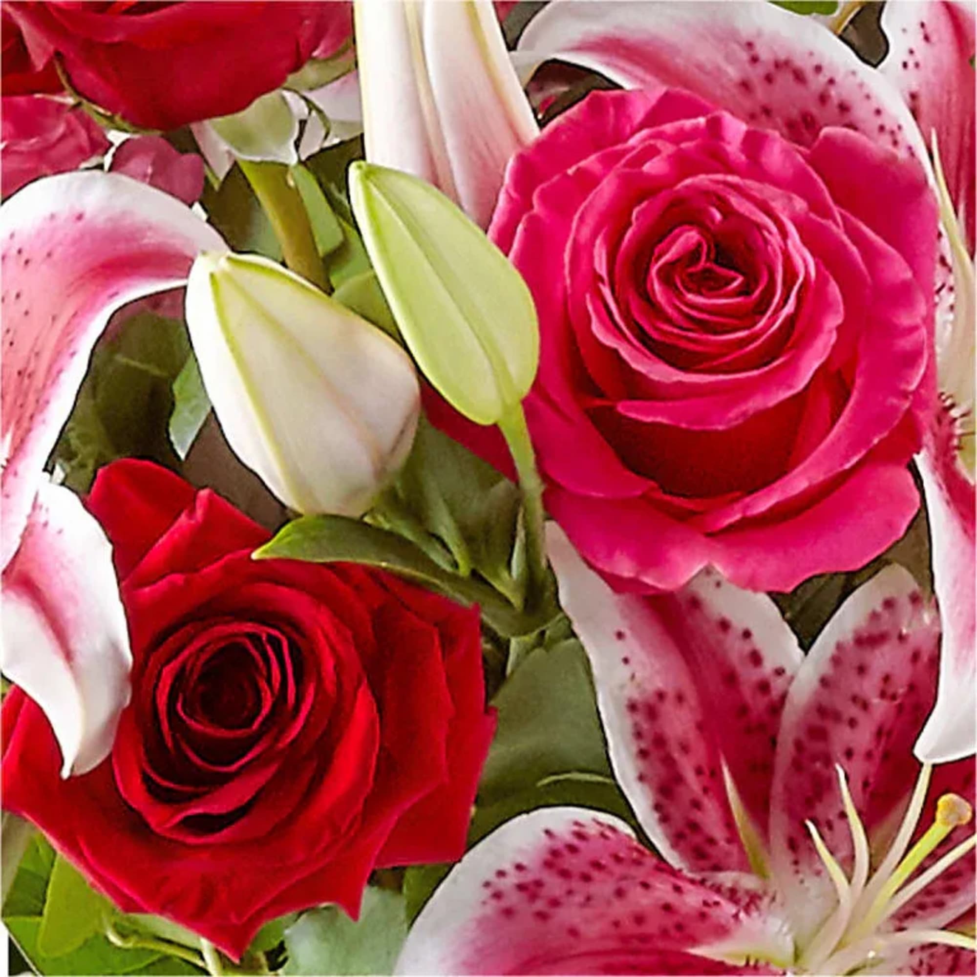 Bouquet of red roses and pink lilies with white lily buds