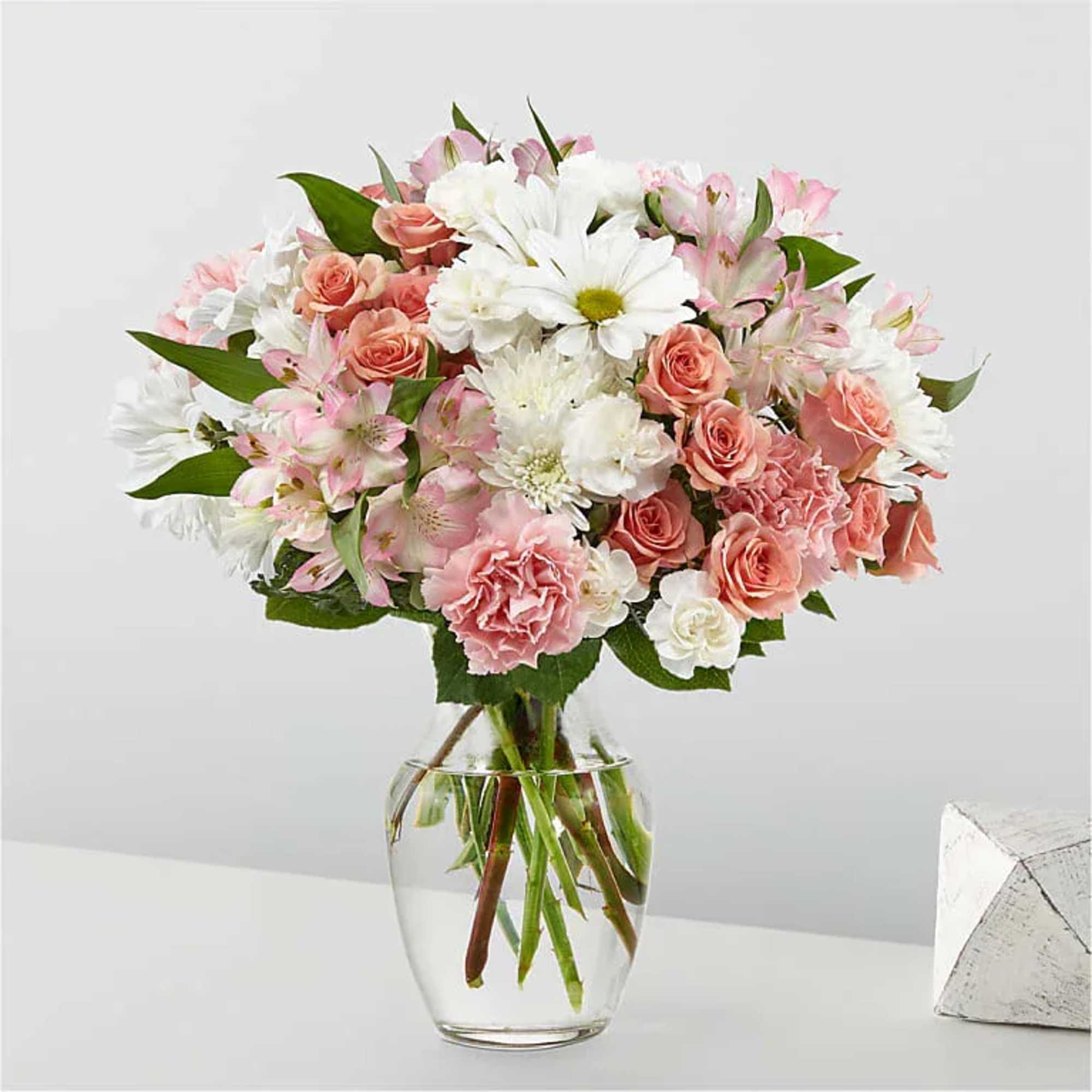 Pink and white mixed bouquet in a clear glass vase
