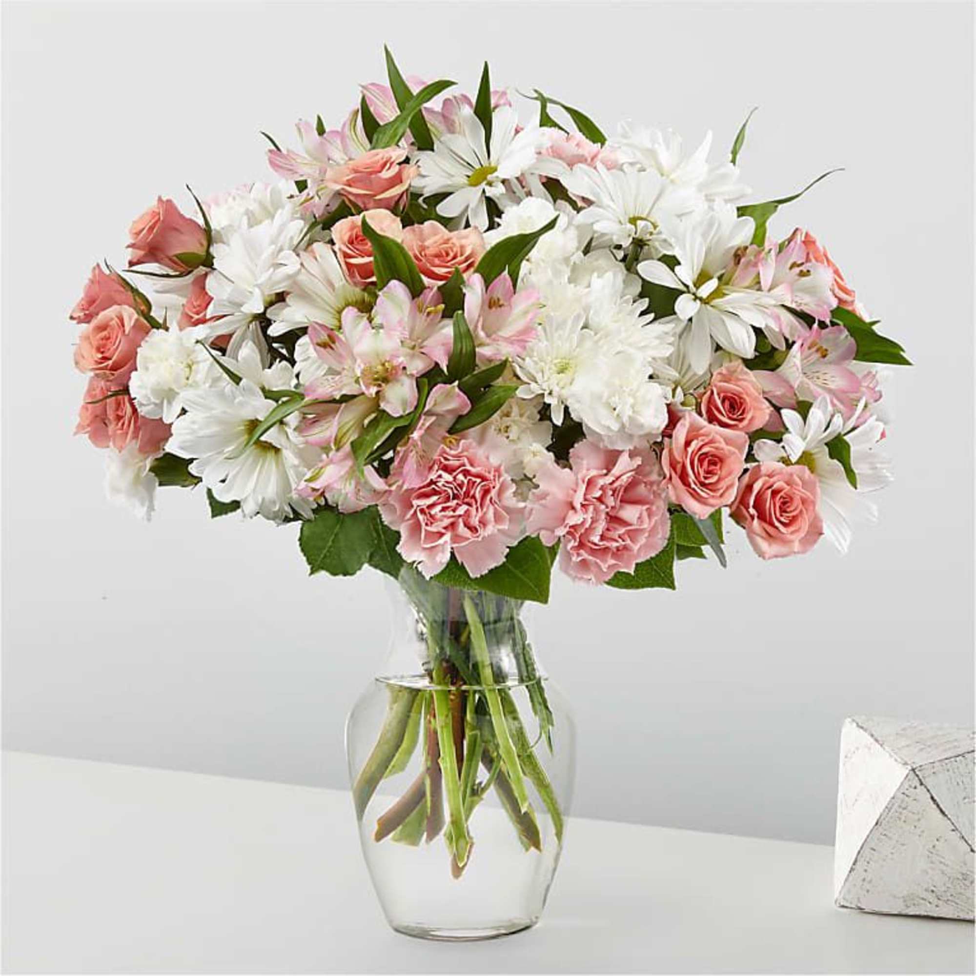 Pink and white mixed bouquet in a clear glass vase
