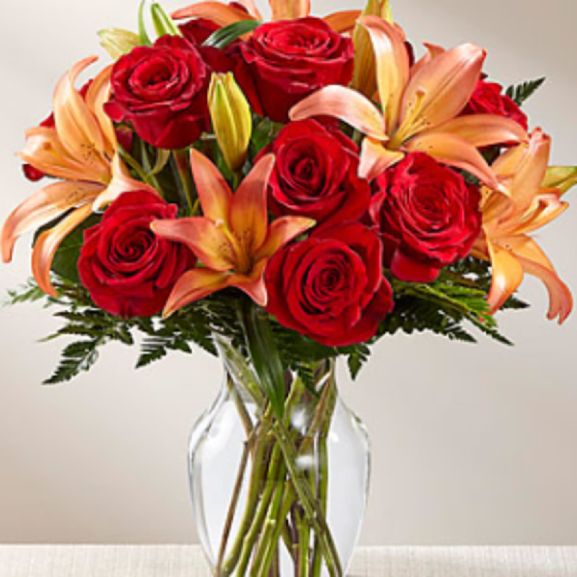 Rich red roses are paired with orange Asiatic Lilies to create a, photo 3 of 3