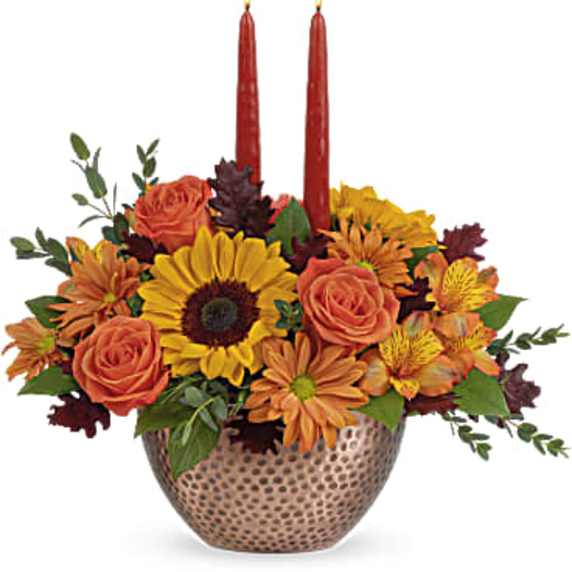 With its shimmering, copper-hued bowl, radiant mix of sunflowers and glowing tapers