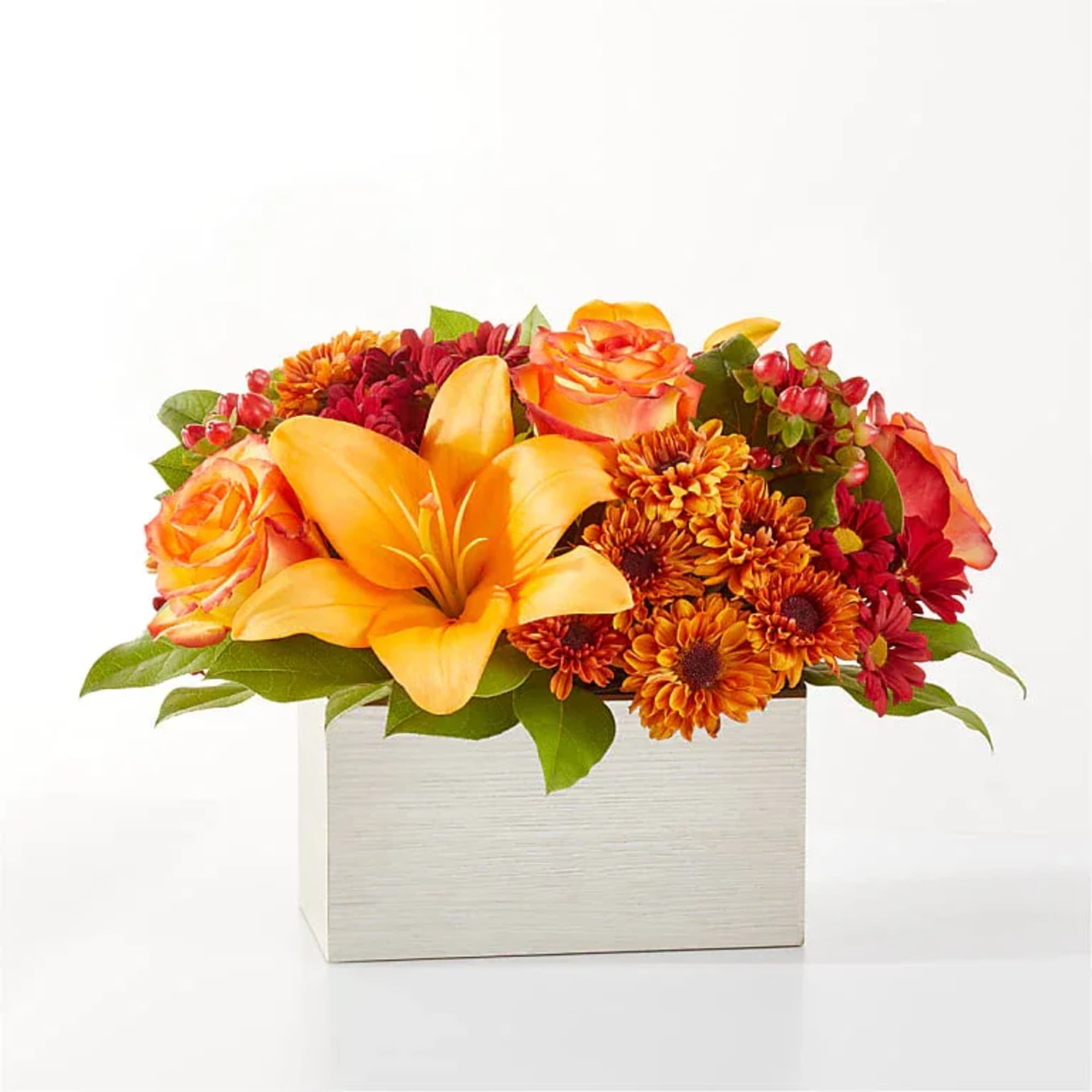 Step into autumn with fiery red and orange petals, expertly arranged to