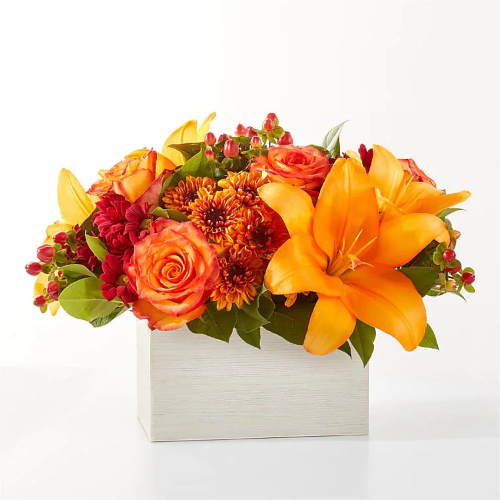Step into autumn with fiery red and orange petals, expertly arranged to