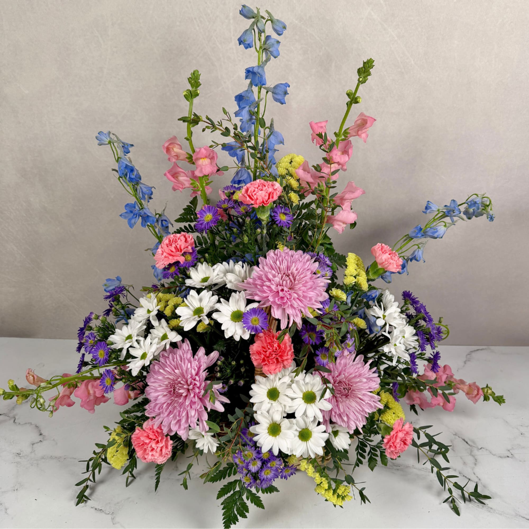 Soft, garden-fresh colors and a gentle, arching silhouette make this flower arrangement, photo 3 of 3